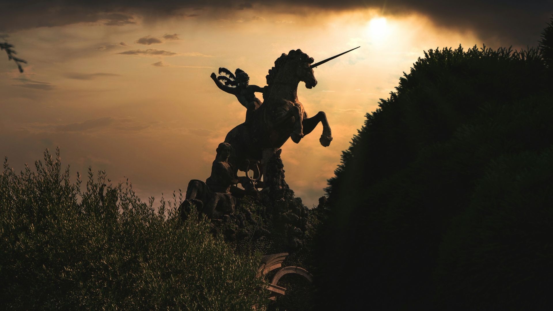 silhouette of man holding stick during sunset