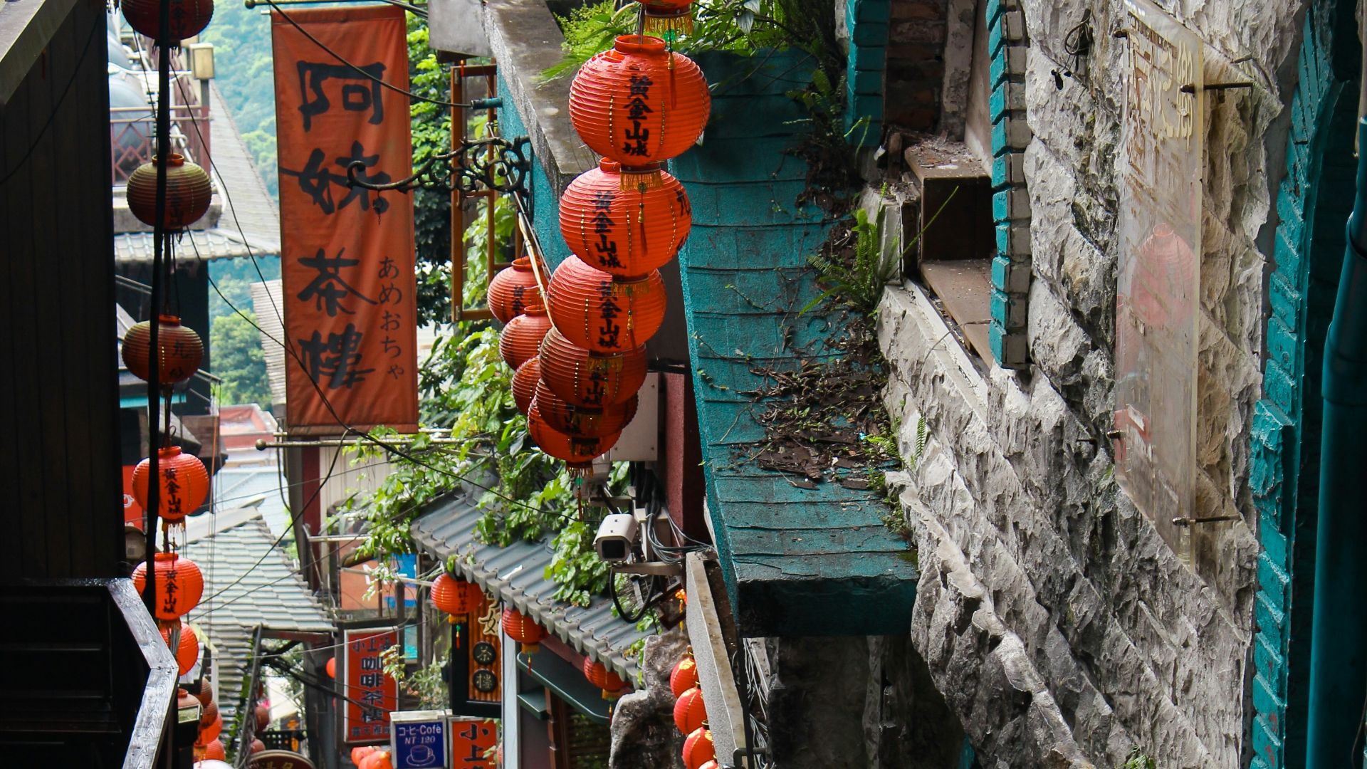 red and brown hanging decors on green concrete wall during daytime