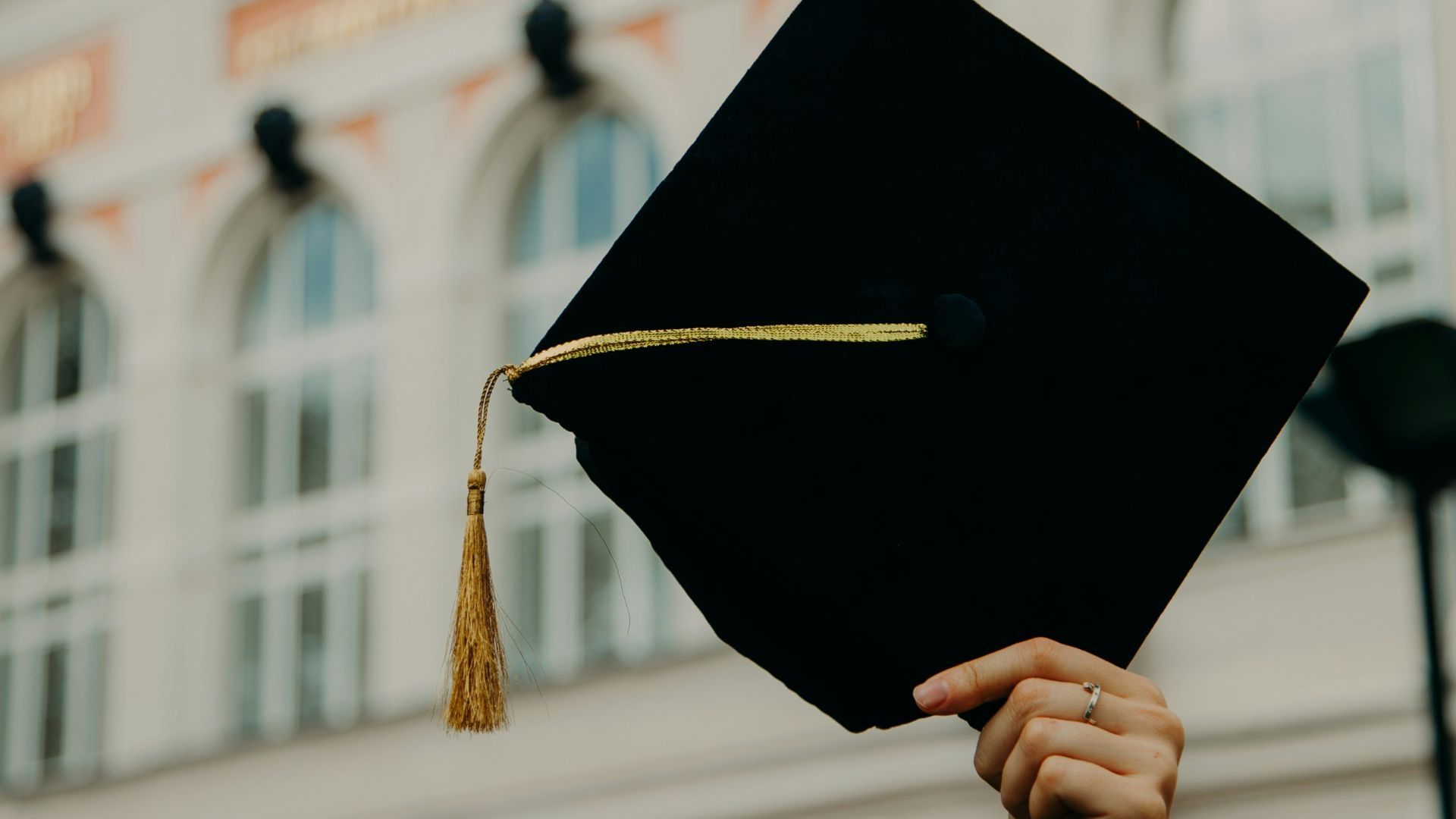 person holding black academic hat