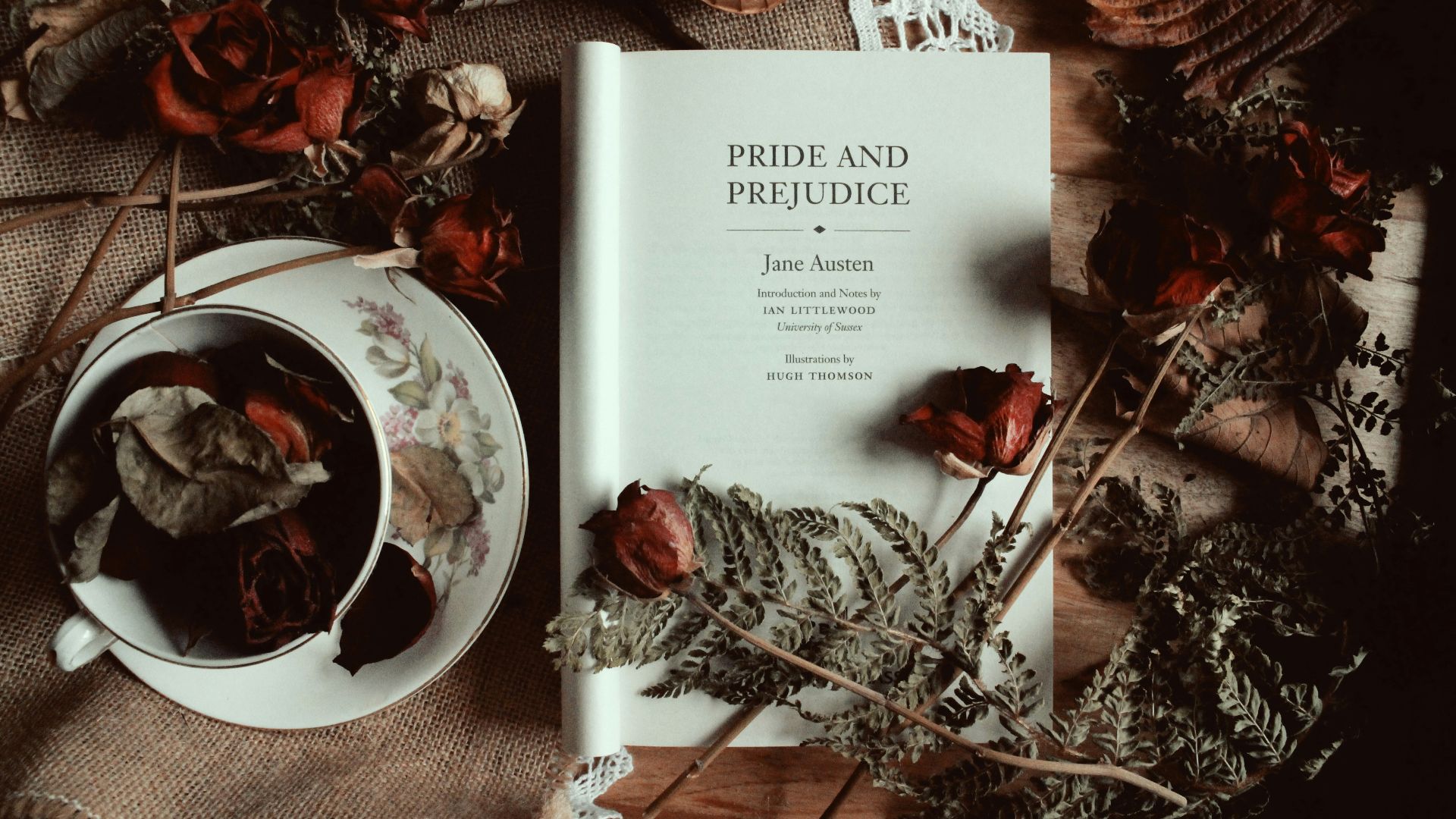 a book sitting on top of a table next to a cup of tea