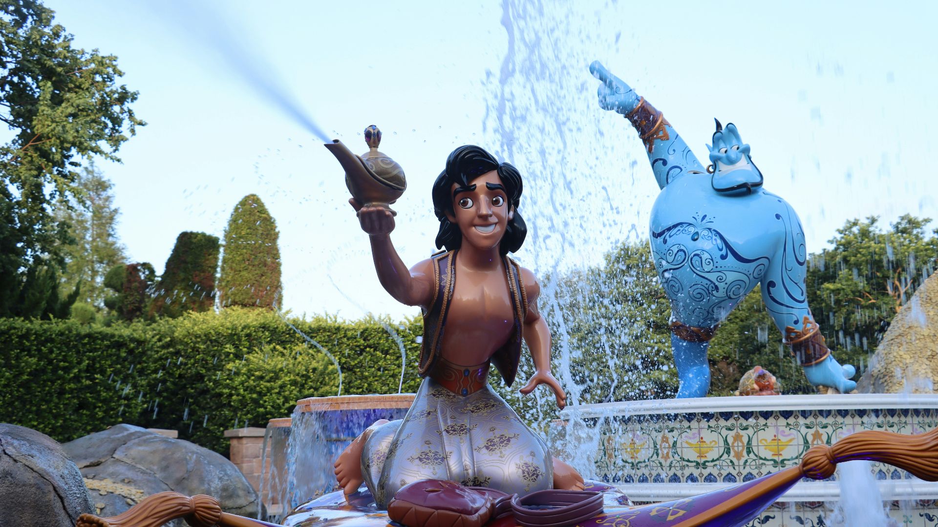 a woman sitting on a fountain with a statue of a man holding a sword