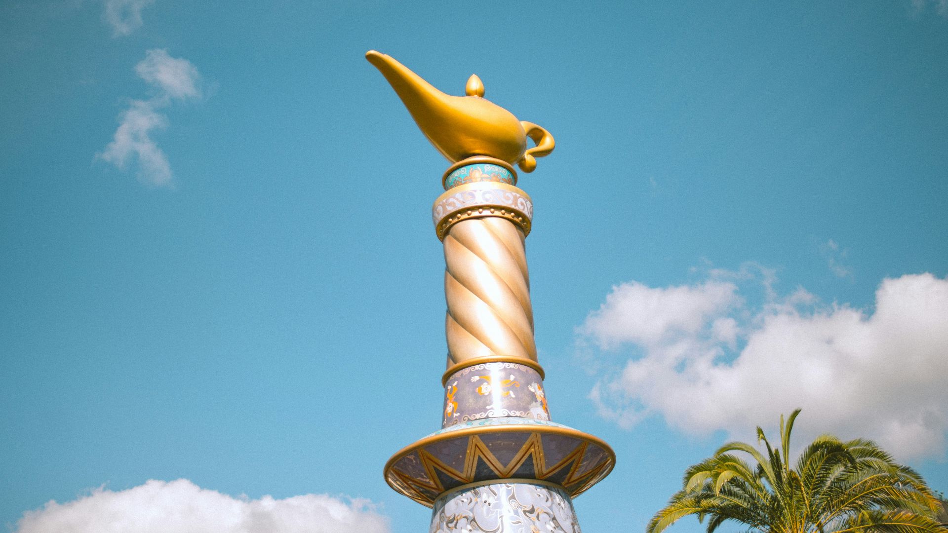 a gold and white statue of a fish on top of a fountain