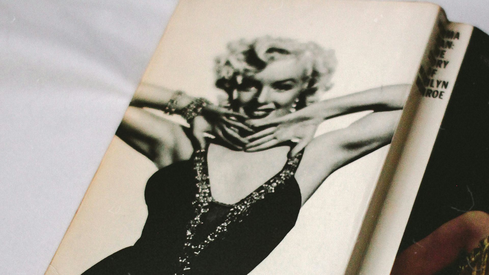 black and white book on white textile