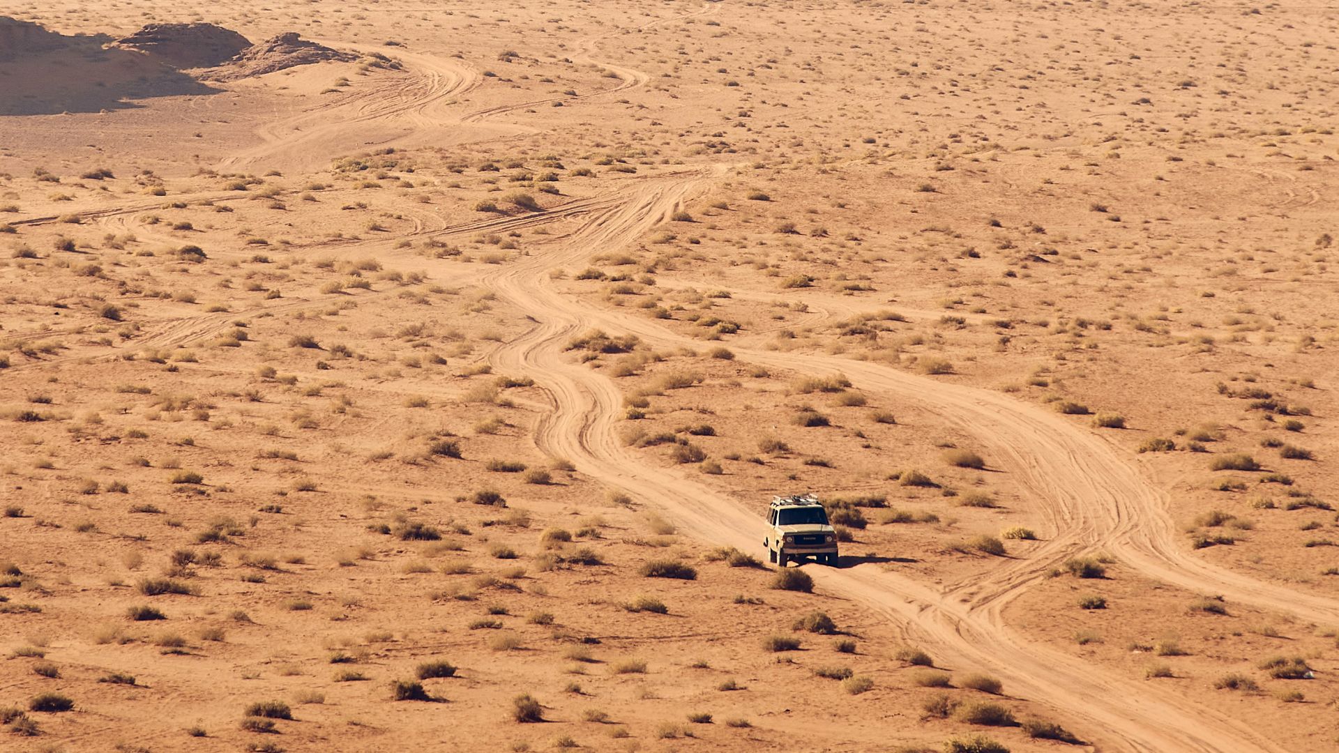 person walking on sand during daytime