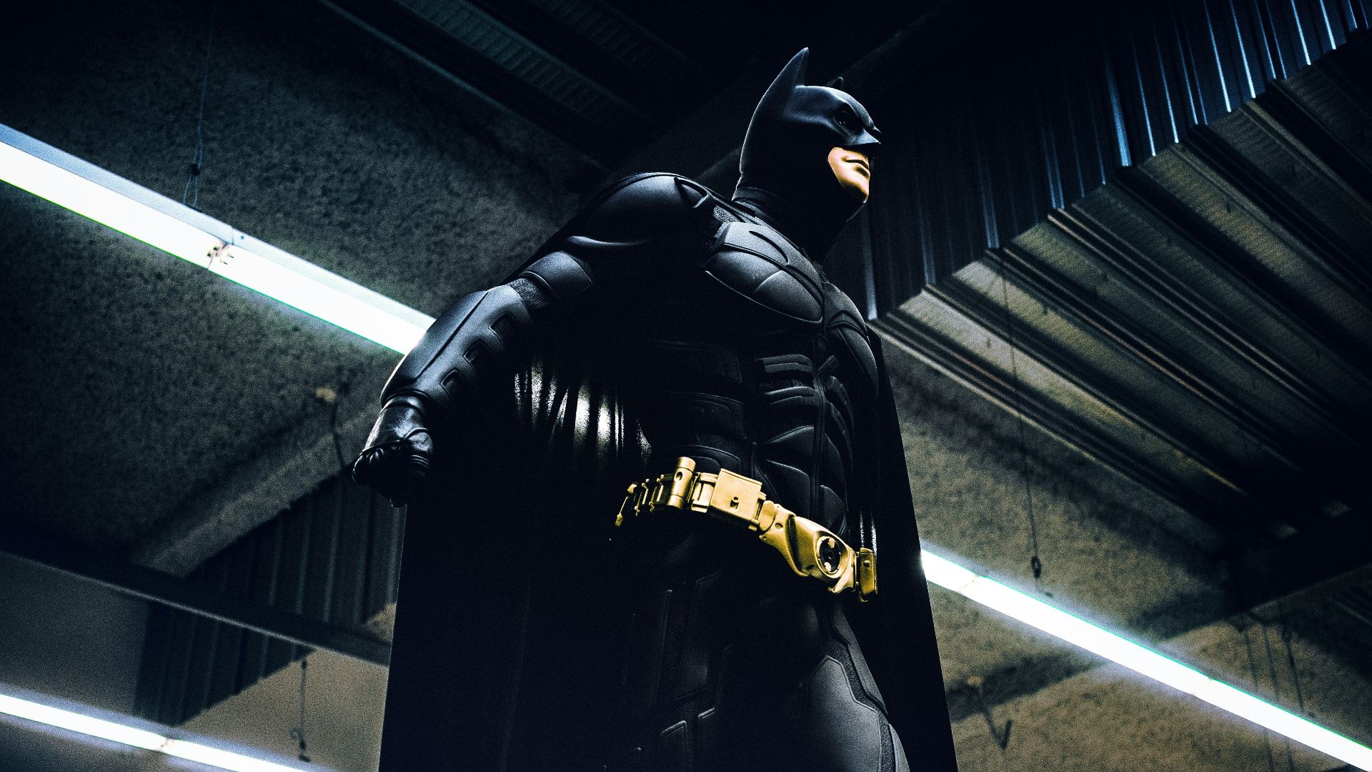Batman standing under steel roof
