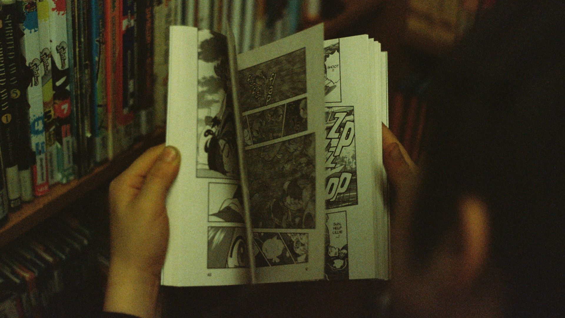 person holding white and black book