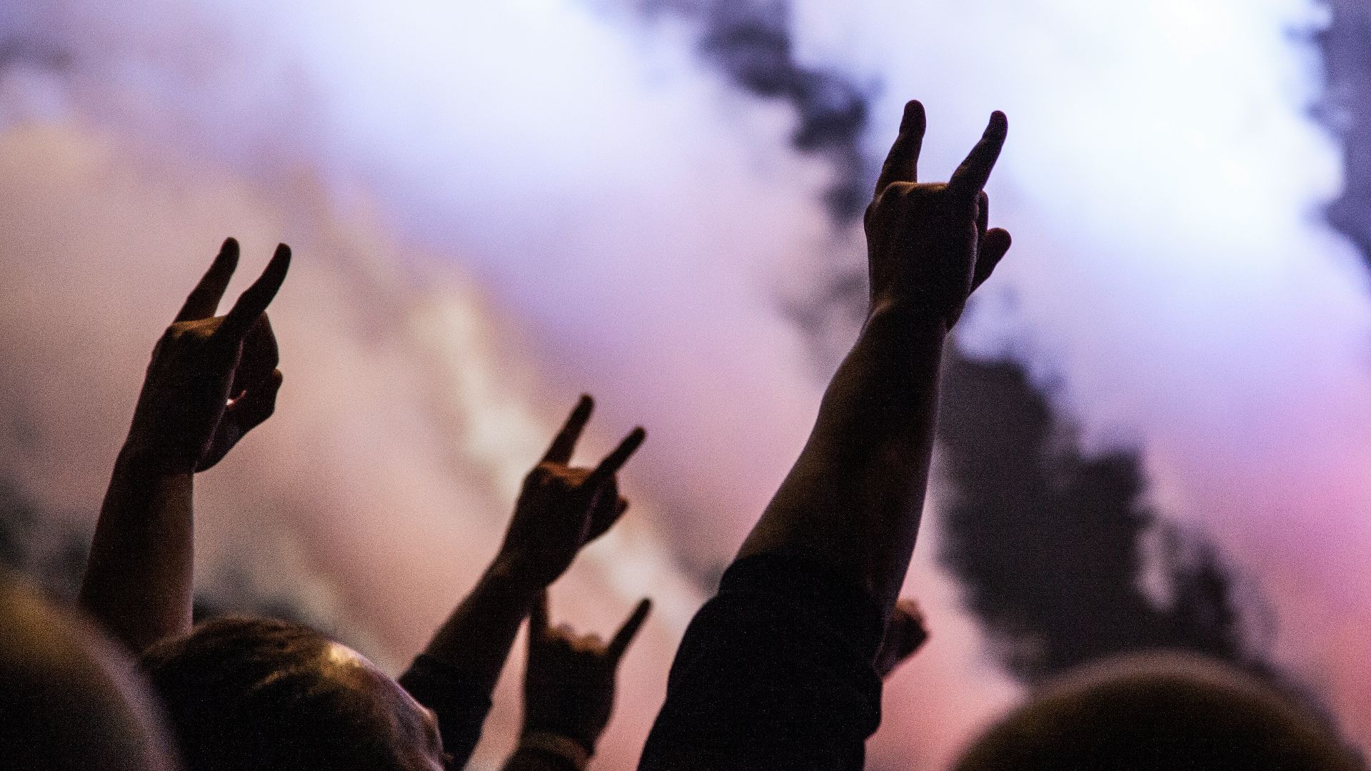 photo of persons doing rock hand sign