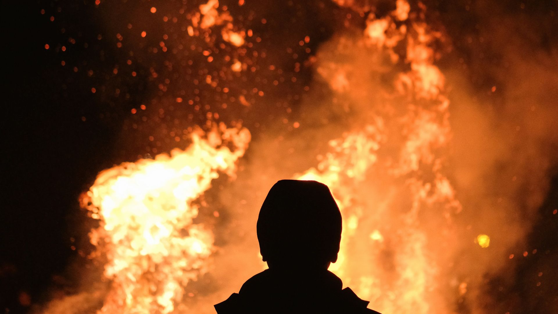 person standing in front of fire