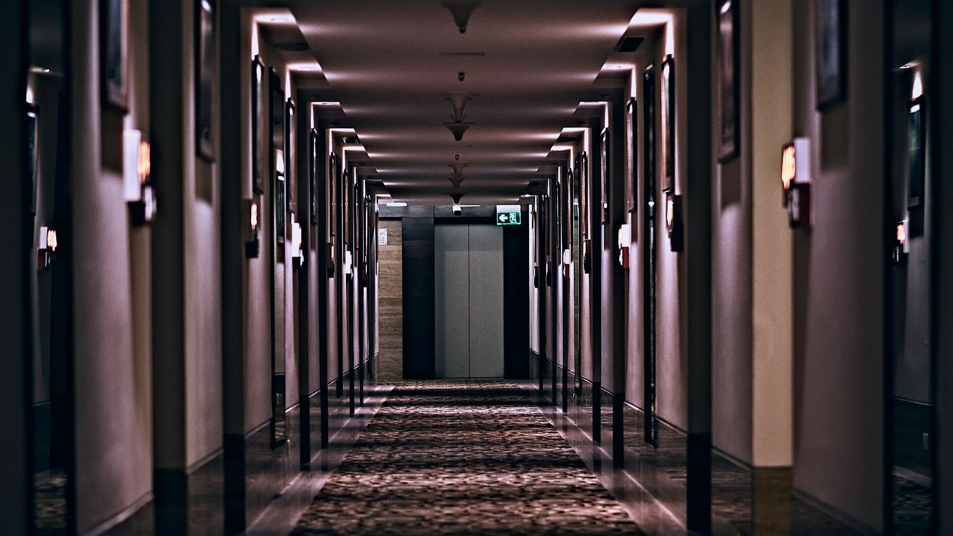 hallway with lights turned on in a hallway