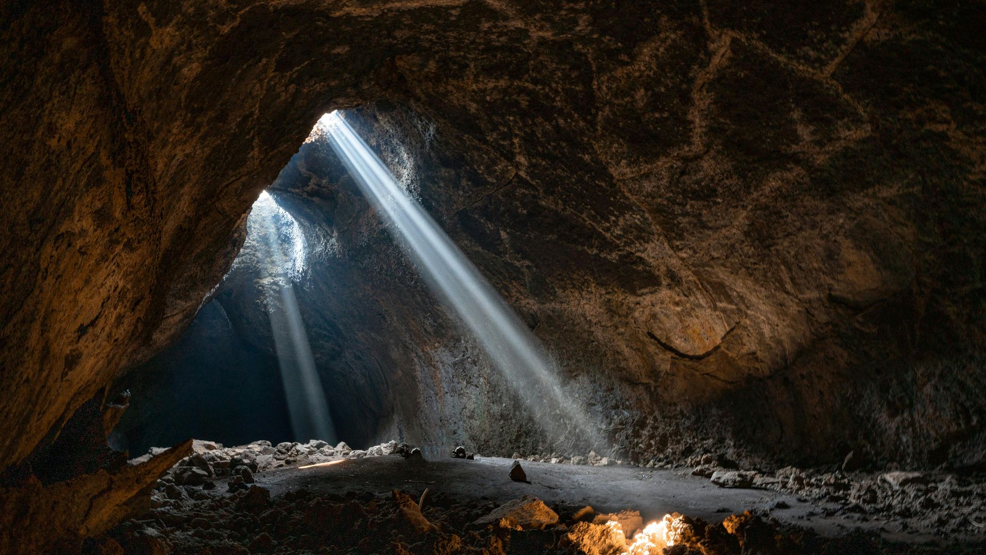 a light shines through the opening of a cave