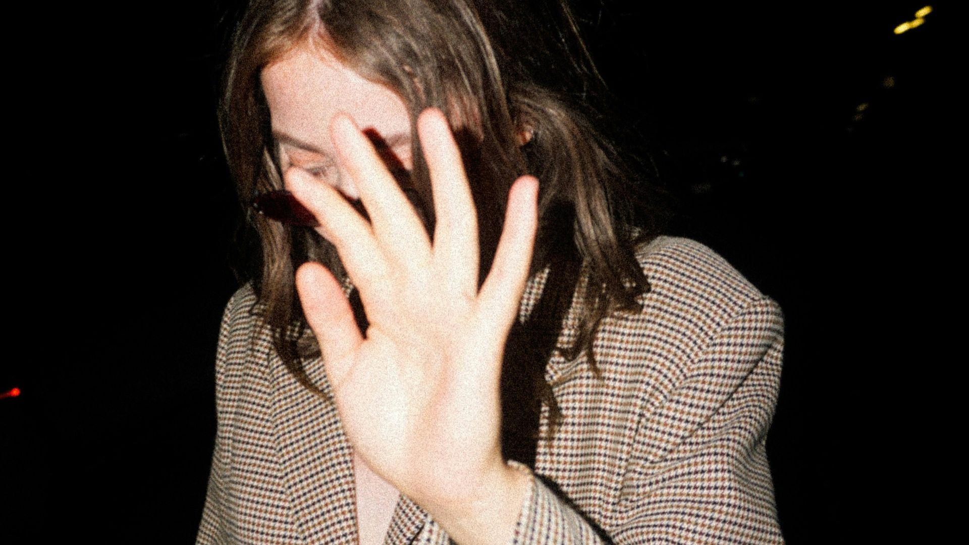 woman covering her face