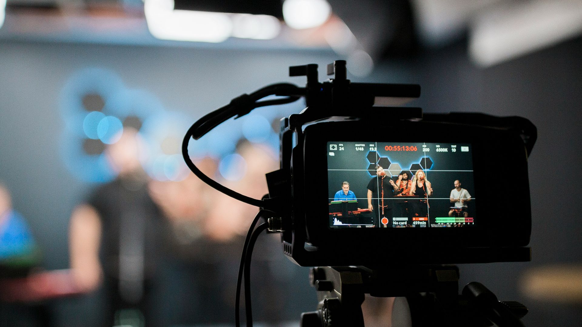 black dslr camera taking photo of city lights