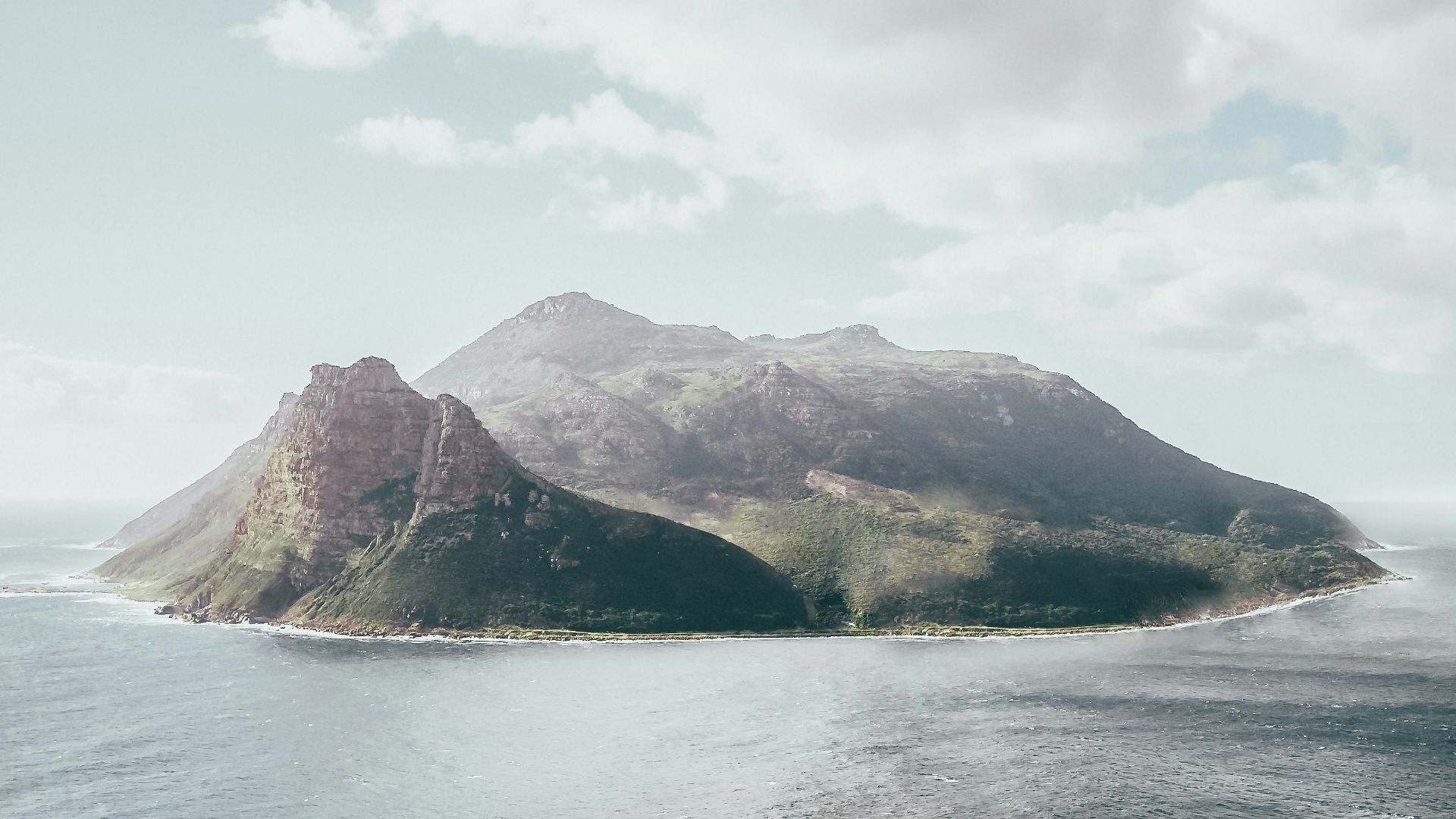 bird's eye view photography of island under white clouds