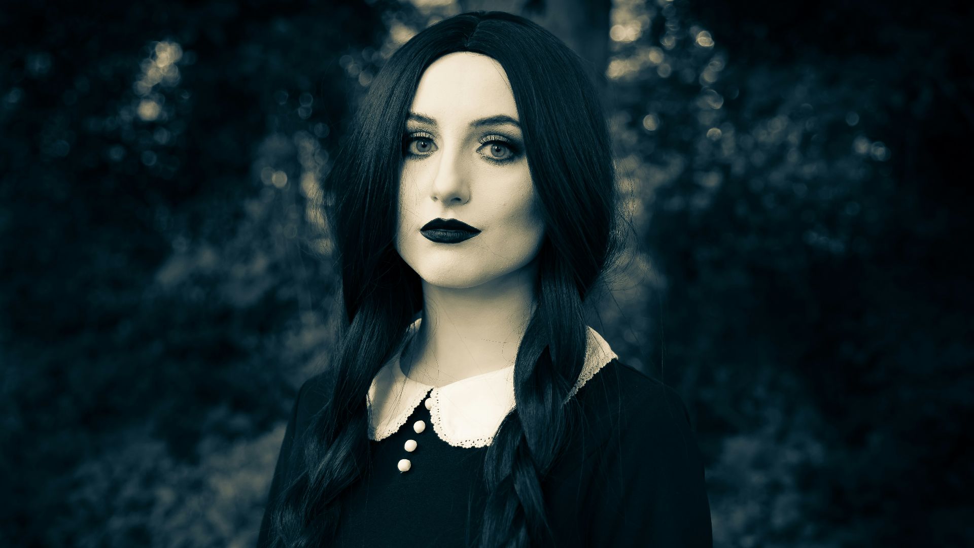 a woman with long black hair and black lipstick