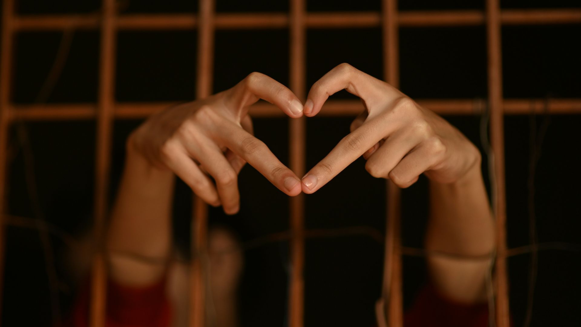 persons hand on brown metal frame