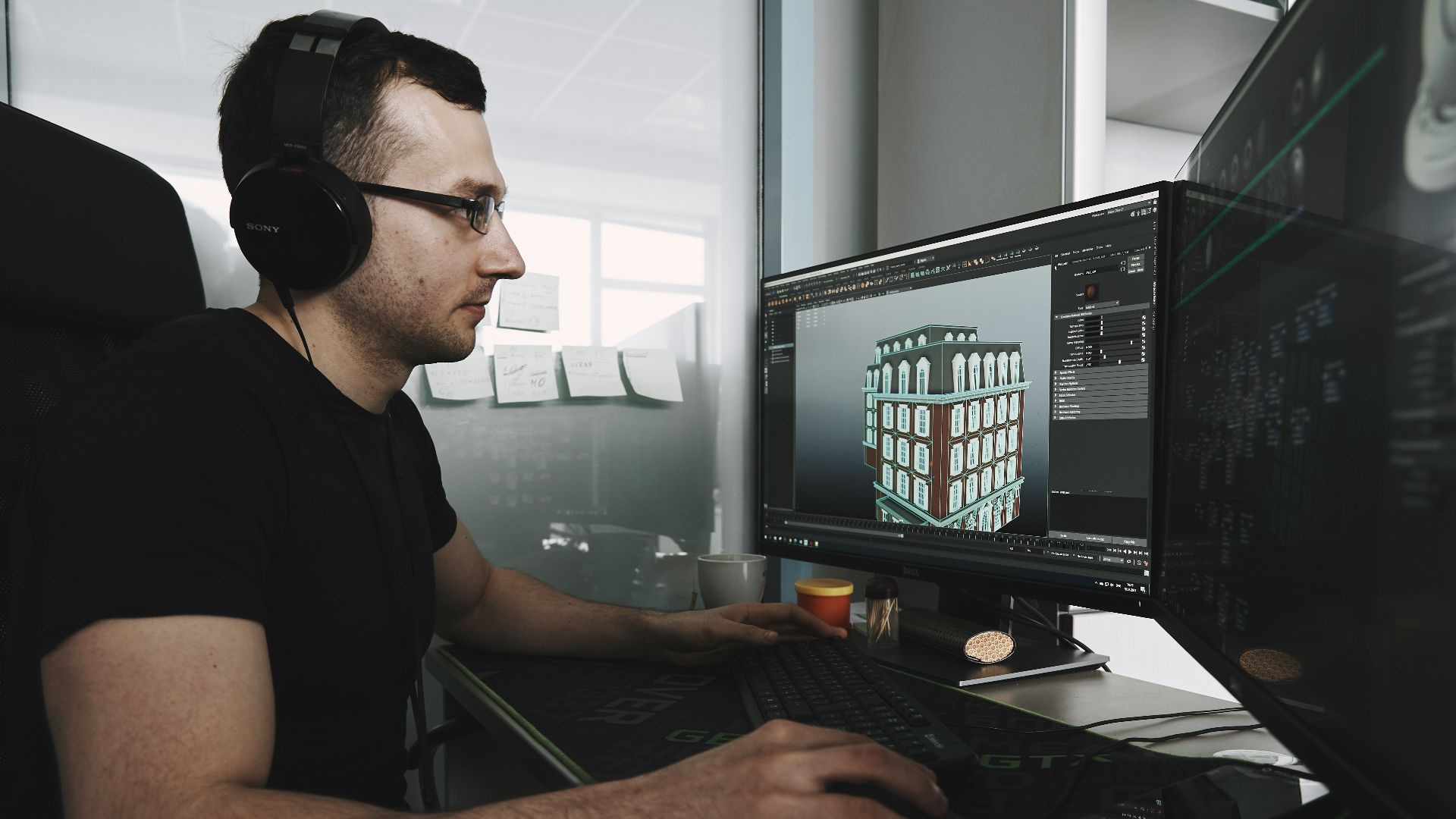 man in black tank top wearing black sunglasses using computer