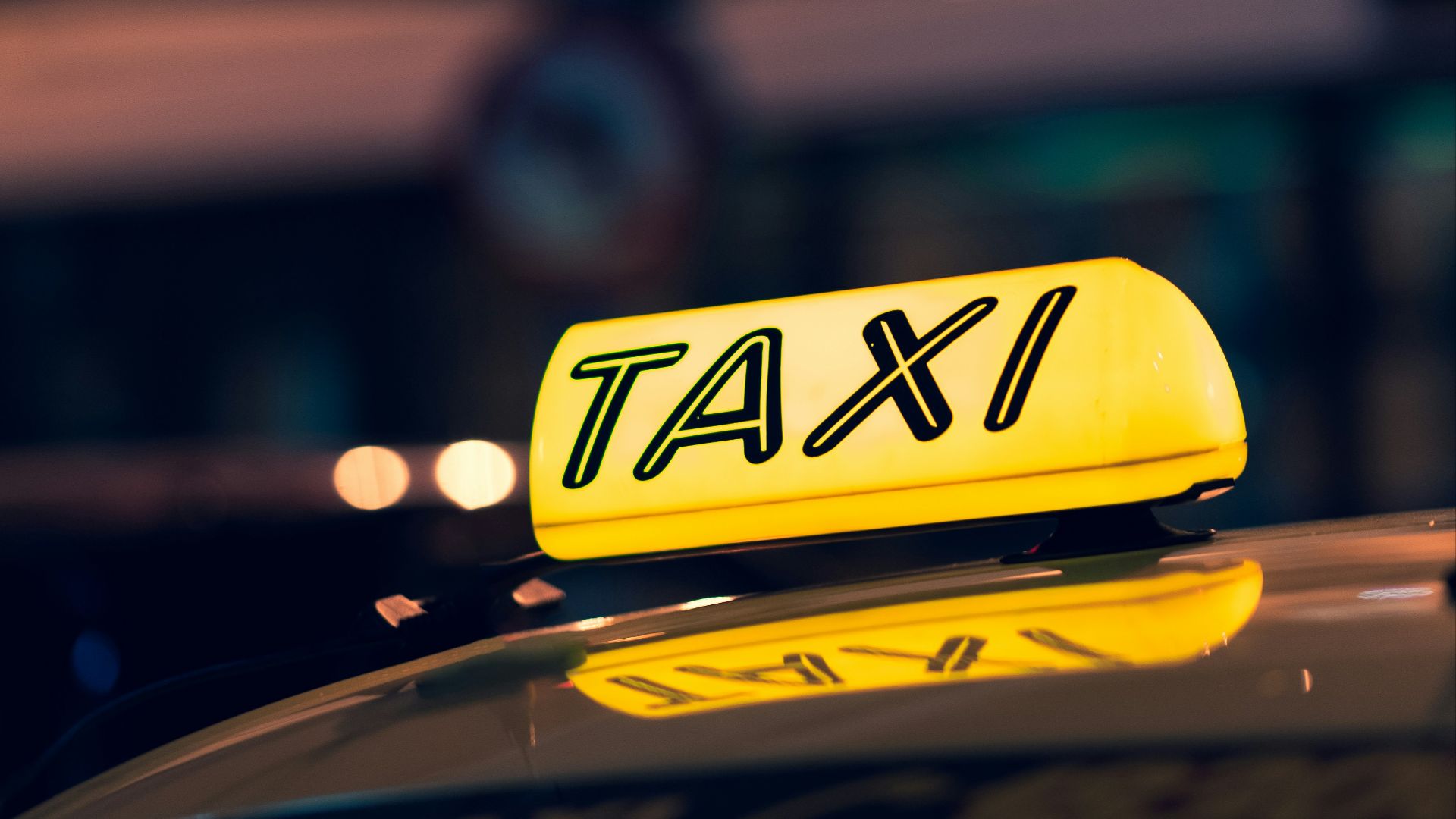 yellow taxi cab on road during night time