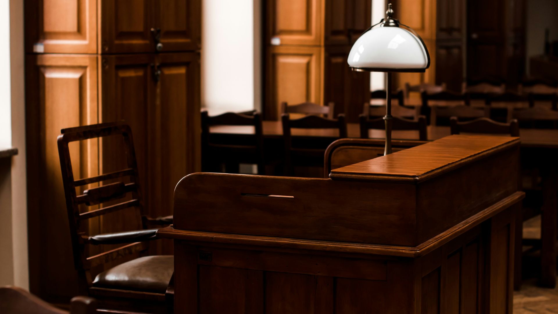 a wooden bar with a lamp on top of it