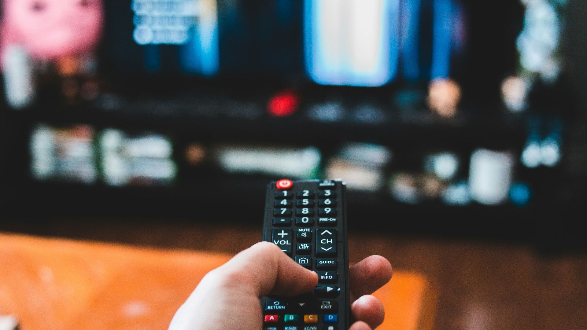 person holding black remote control