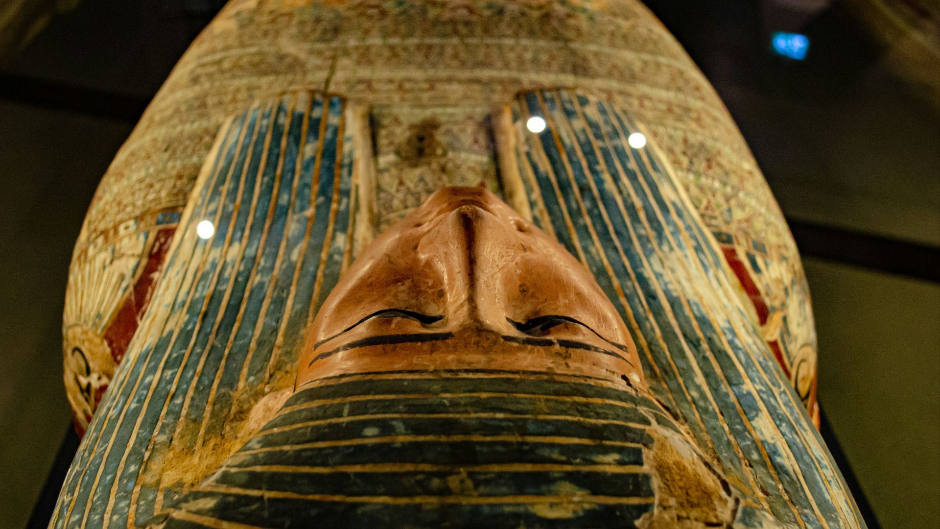 brown wooden tribal mask on brown wooden table