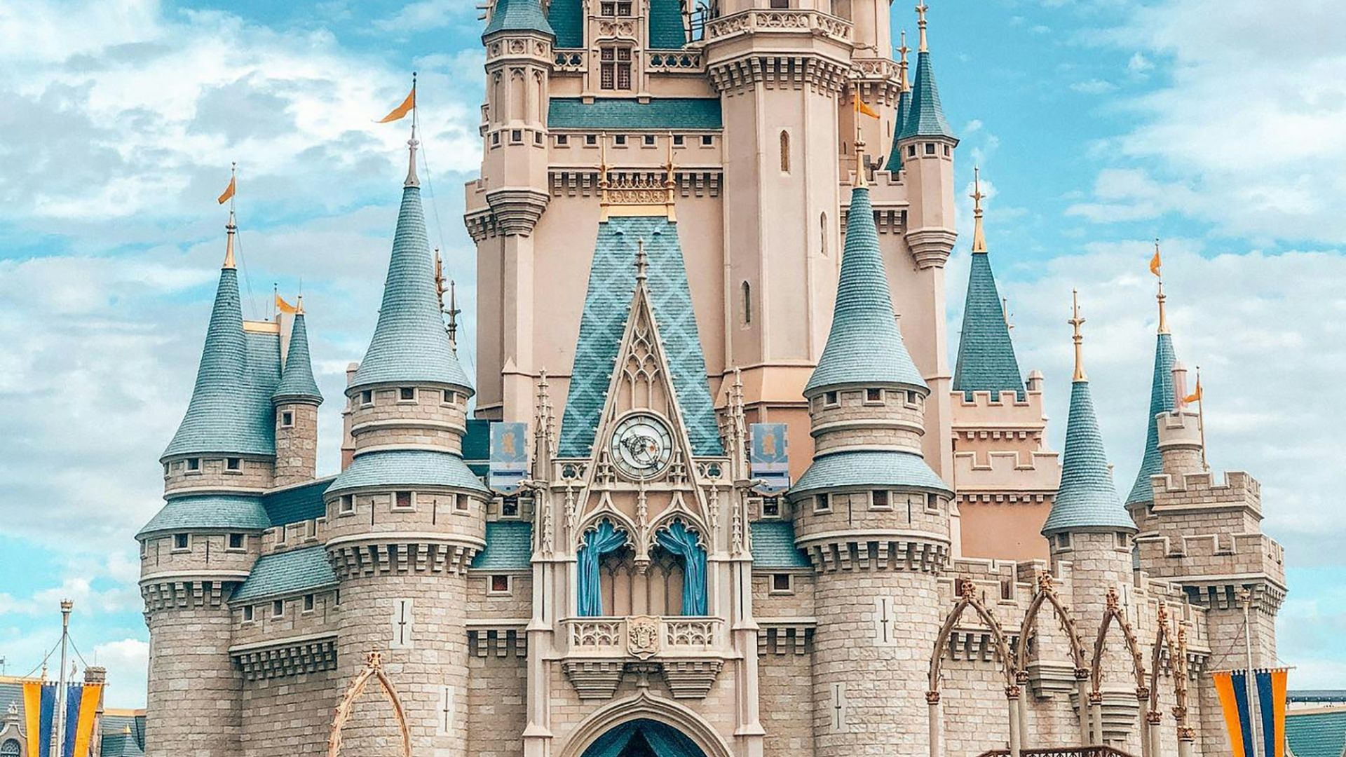 white and blue castle under blue sky and white clouds during daytime