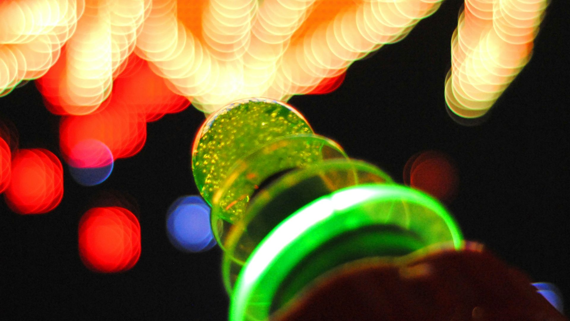 person holding green glass bottle