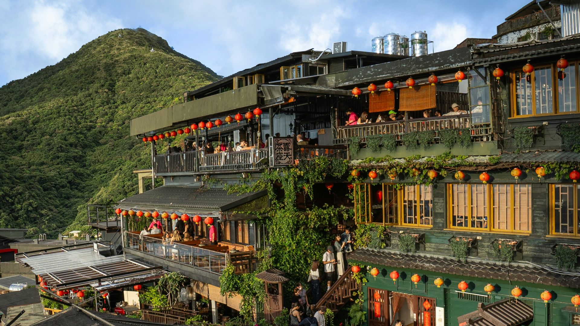 A group of buildings with a mountain in the background