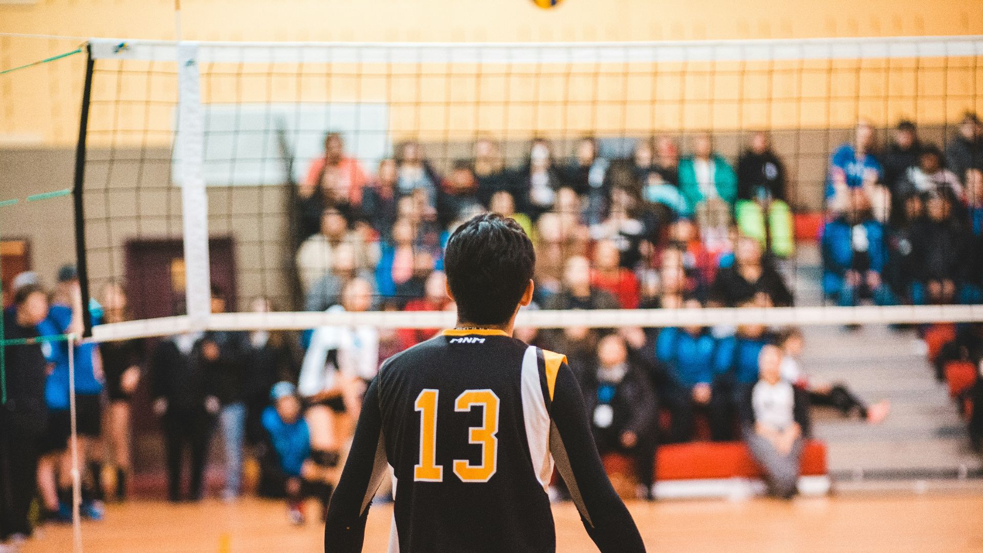 man wearing black 13 volleyball jersey