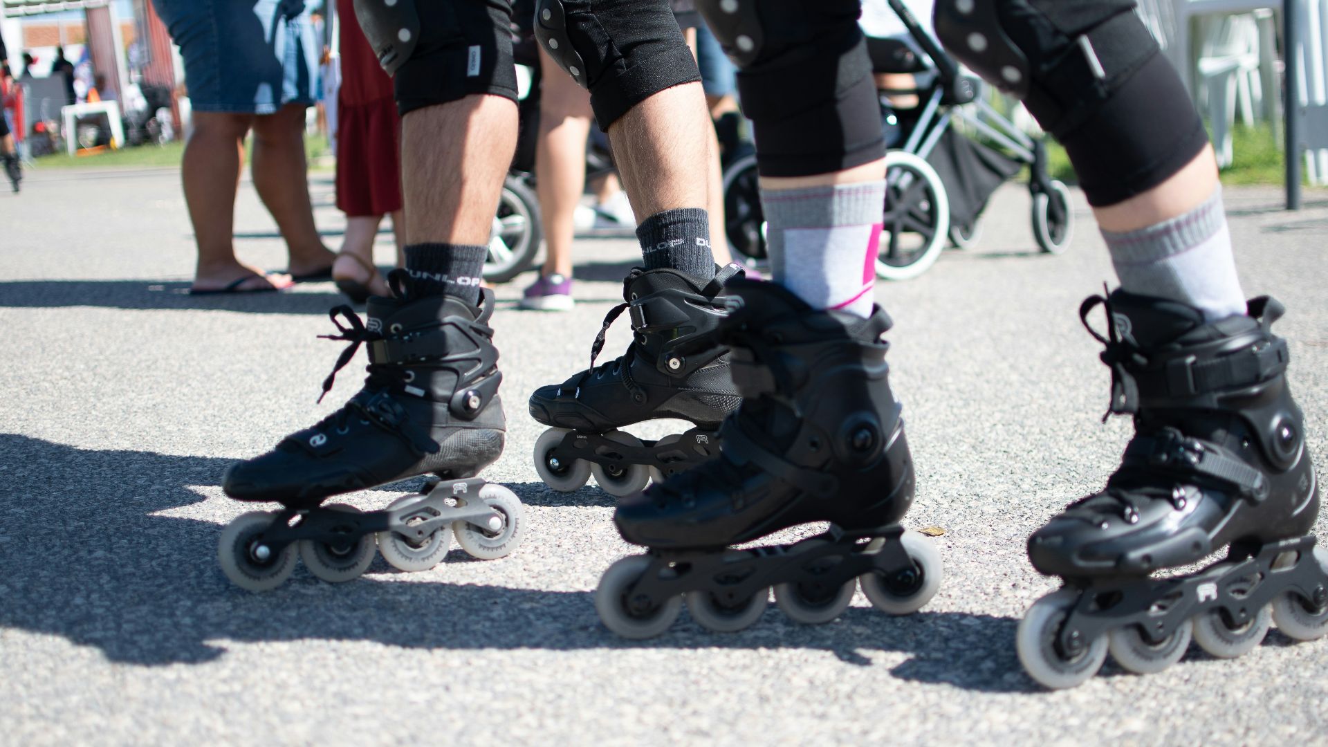 a group of people riding roller skates down a street
