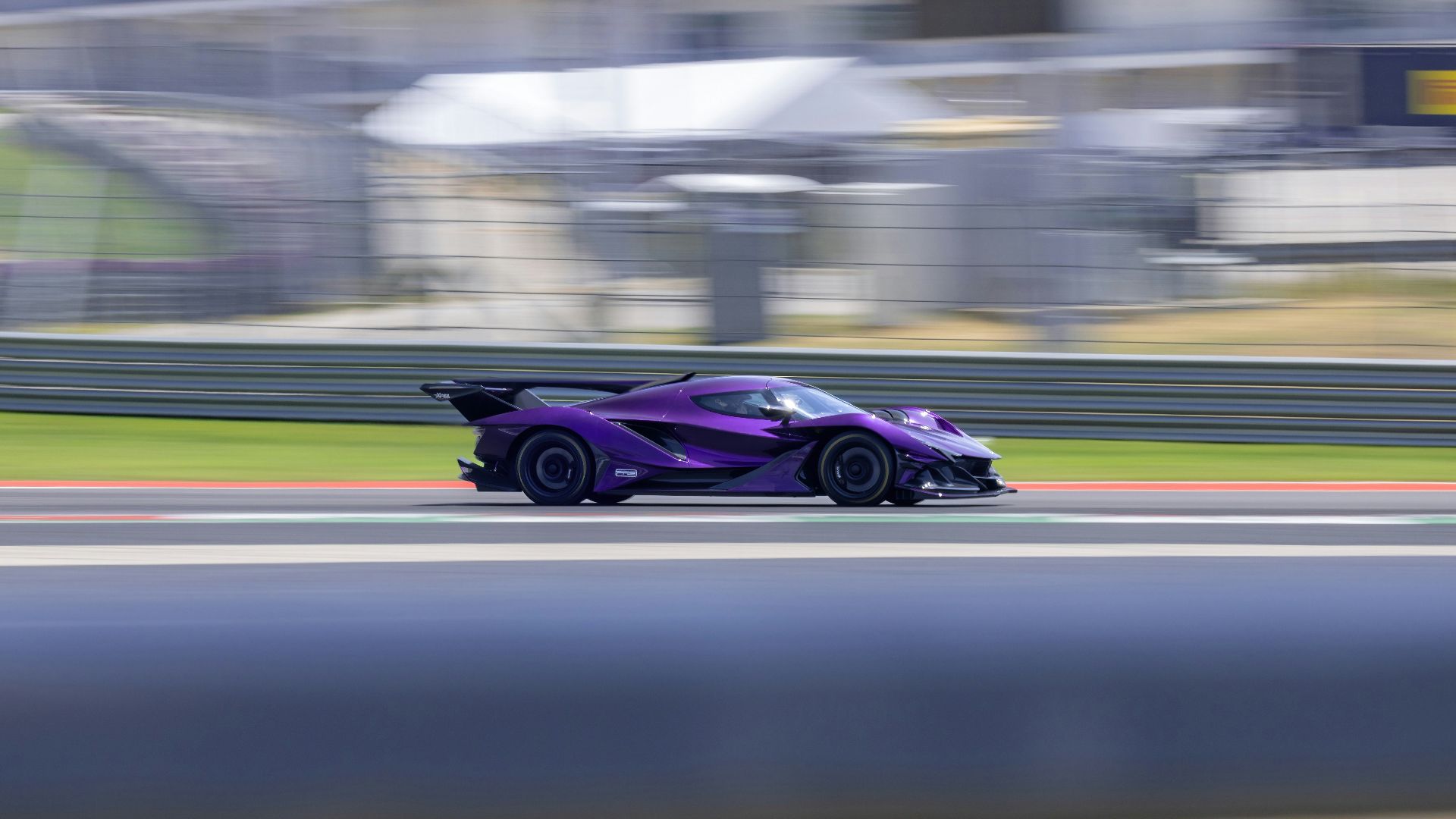 A purple race car driving down a track