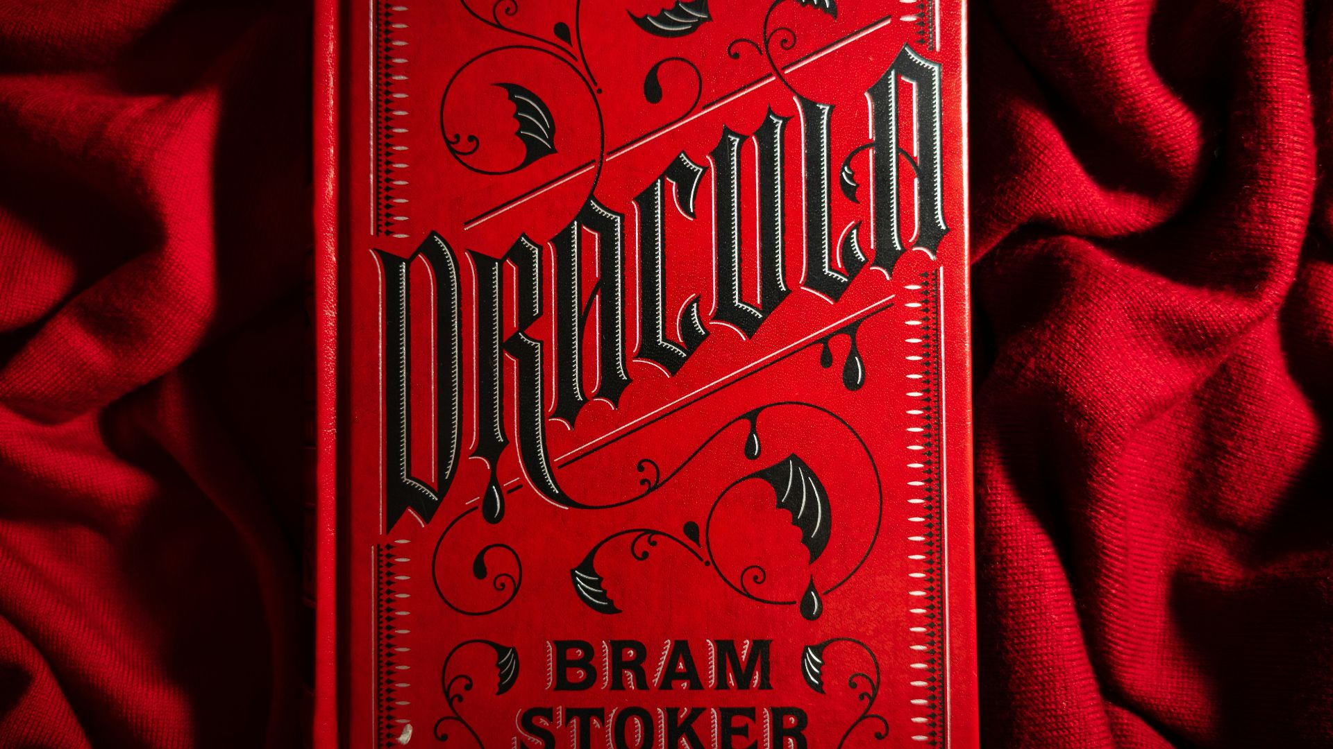 a red book sitting on top of a red blanket