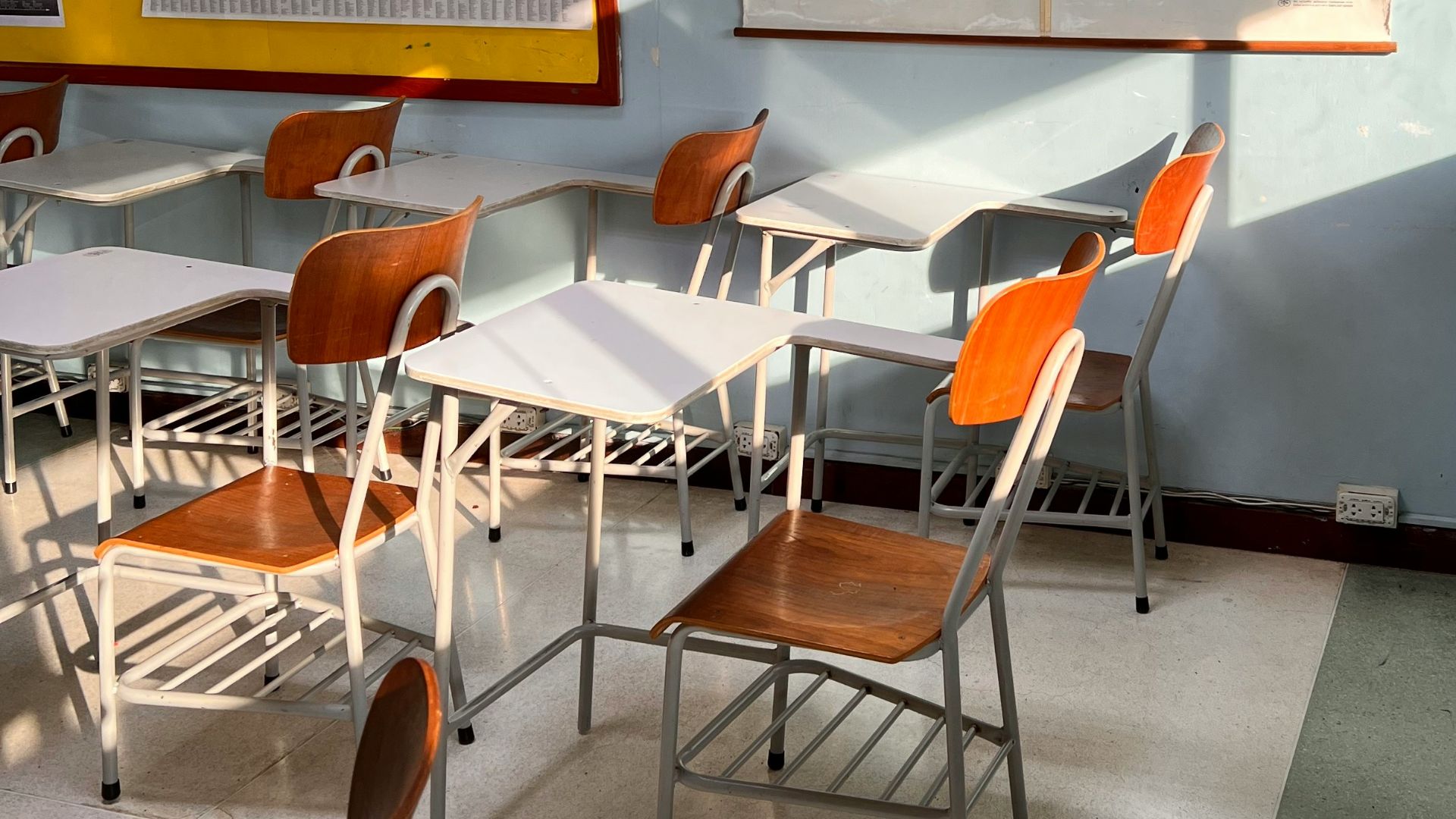 a classroom with a map hanging on the wall
