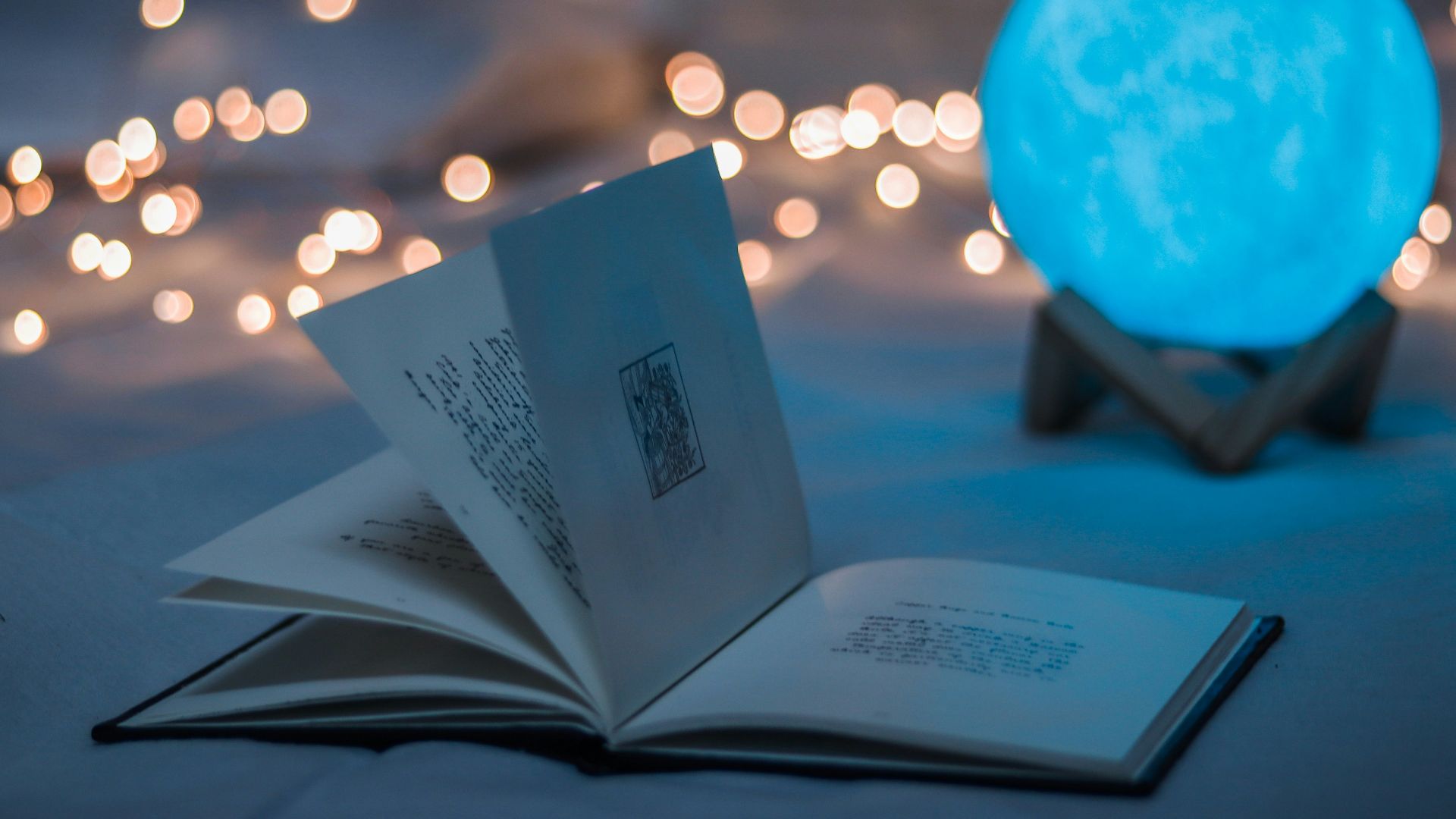opened book beside crystal ball