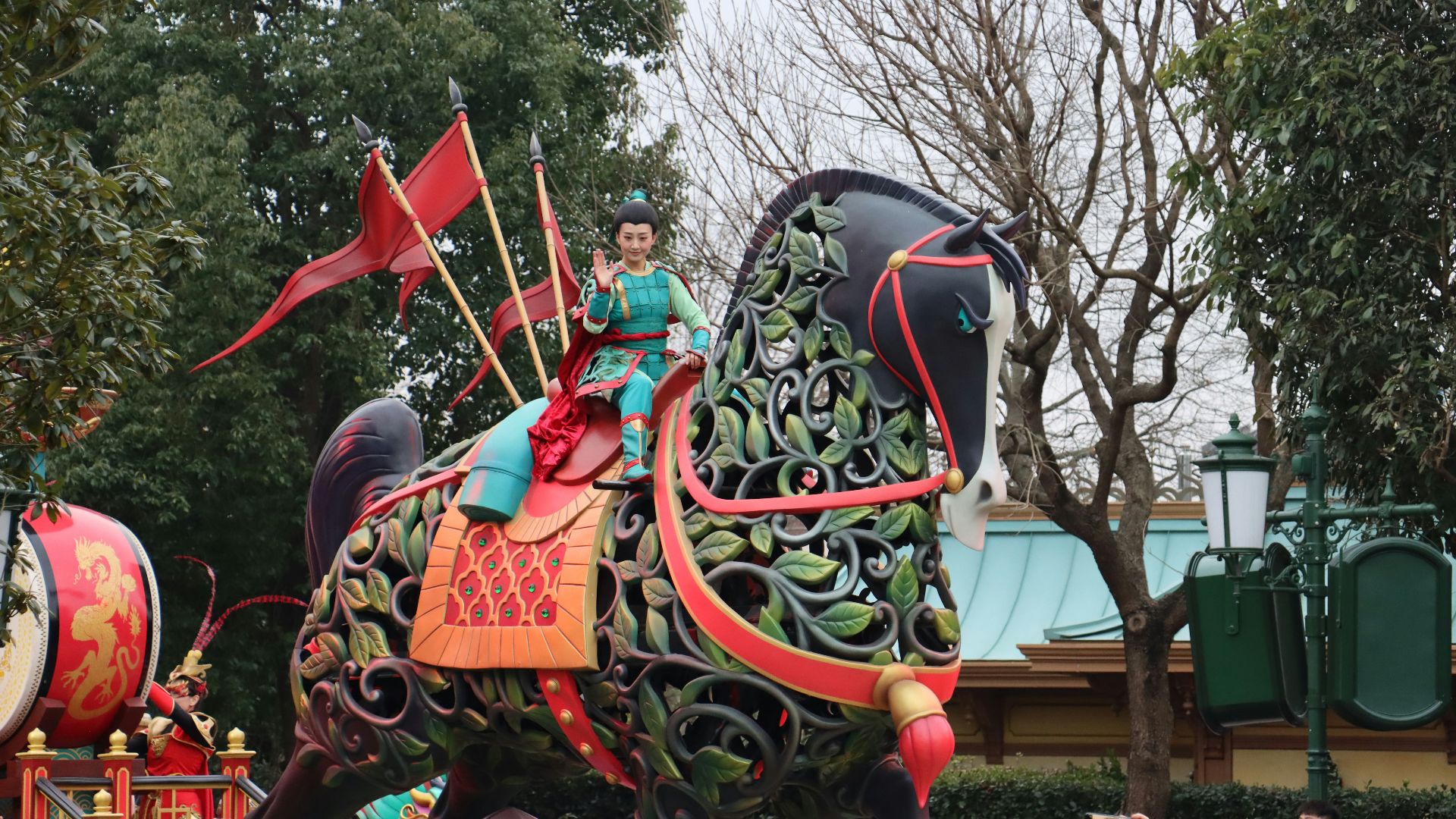 a woman riding on the back of a decorated elephant