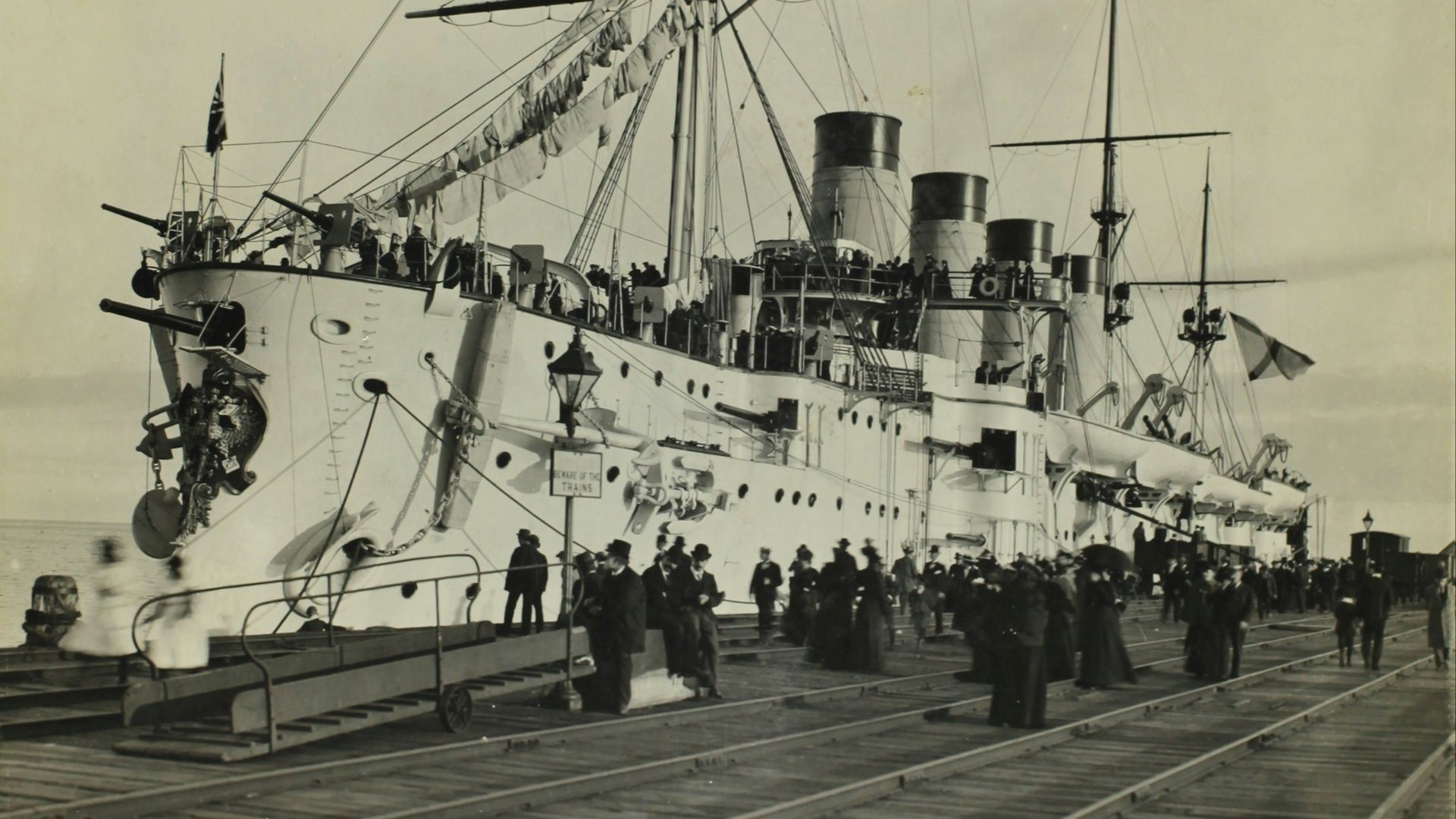 grayscale photo of ship on pier