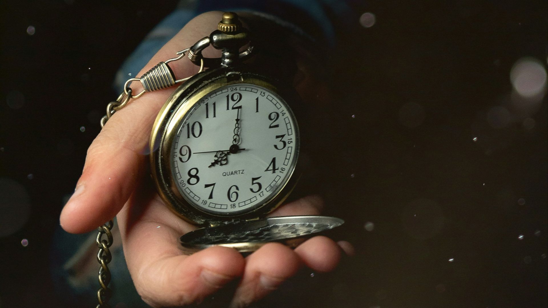 a person holding a clock in their hand