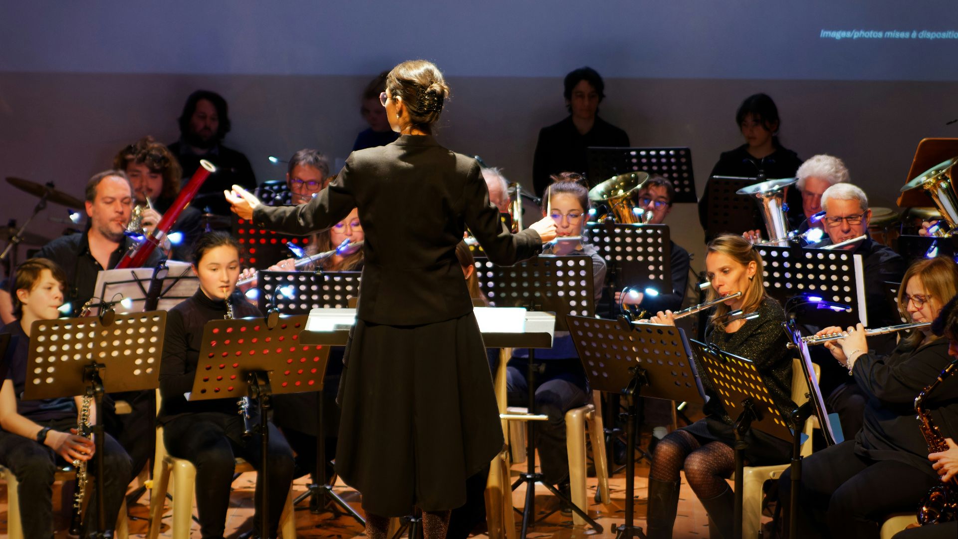Conductor leads orchestra during a performance