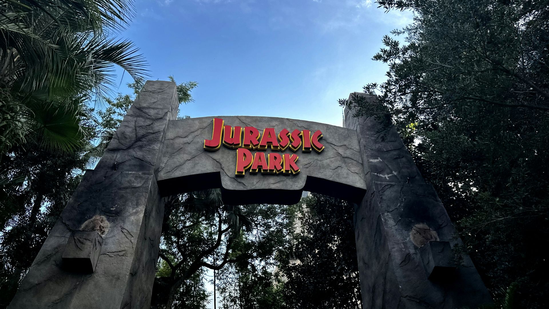 a sign for a park with a sky background