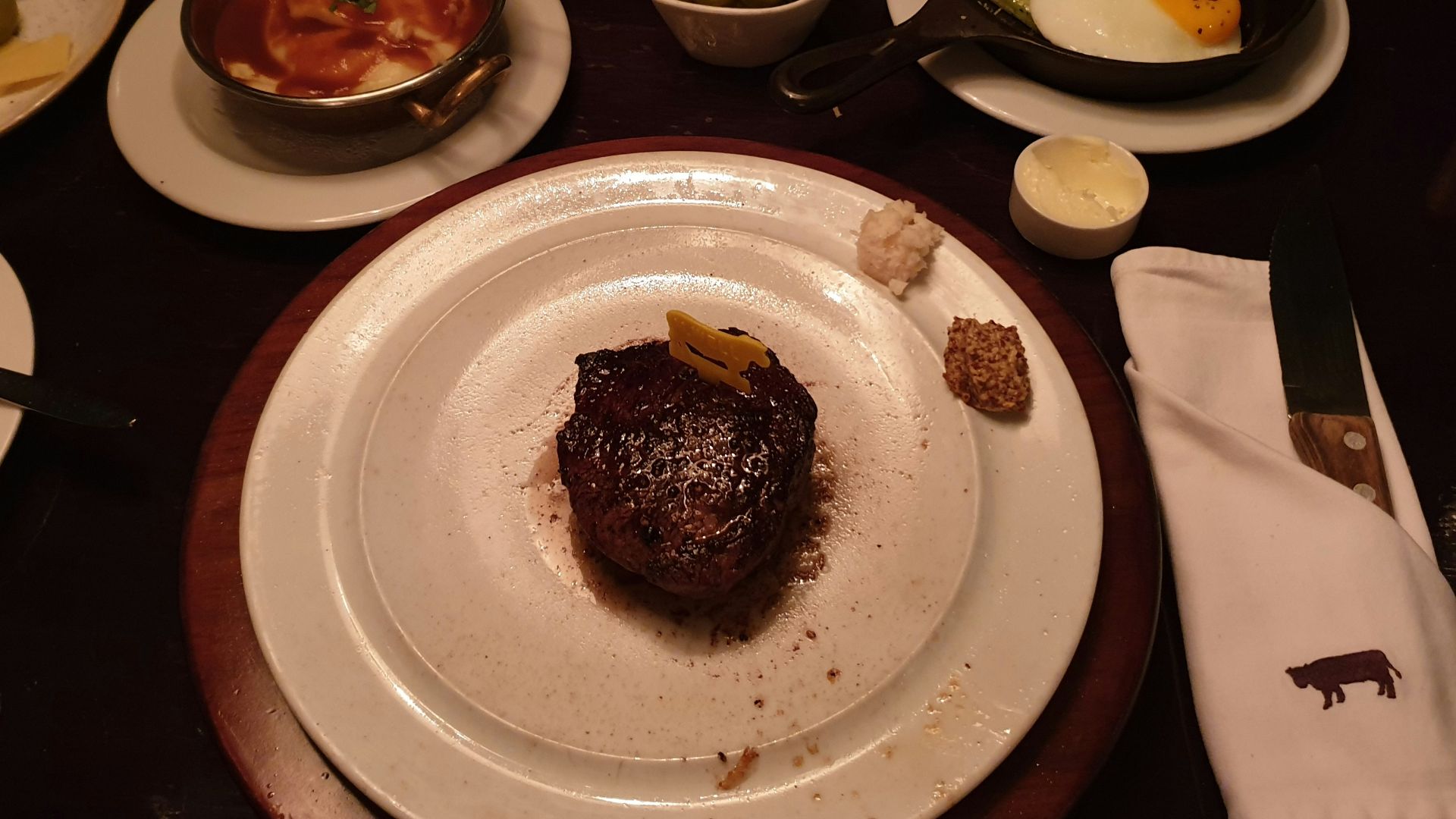 a table topped with plates of food and utensils