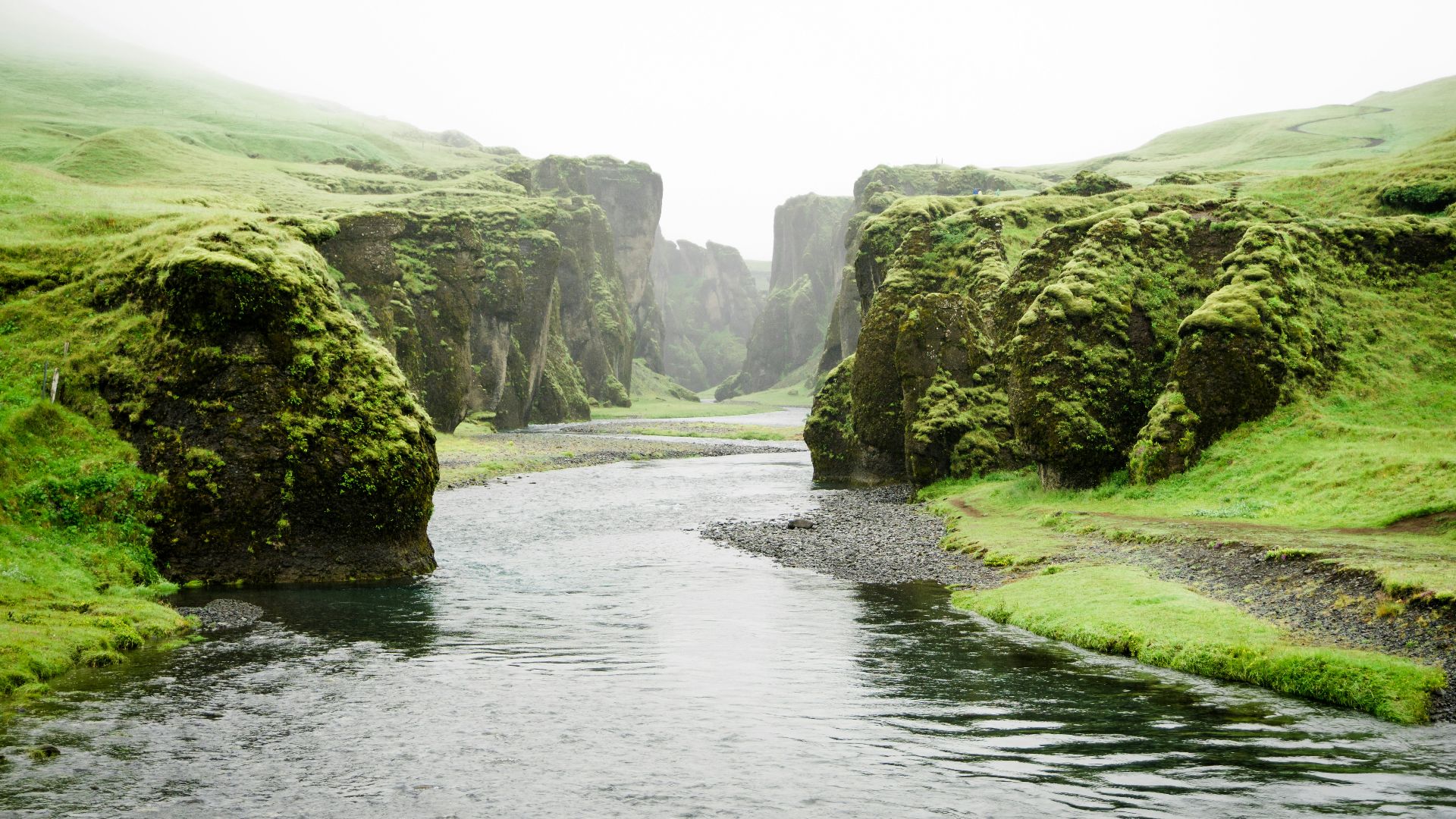 landscape photography of river between green mountains