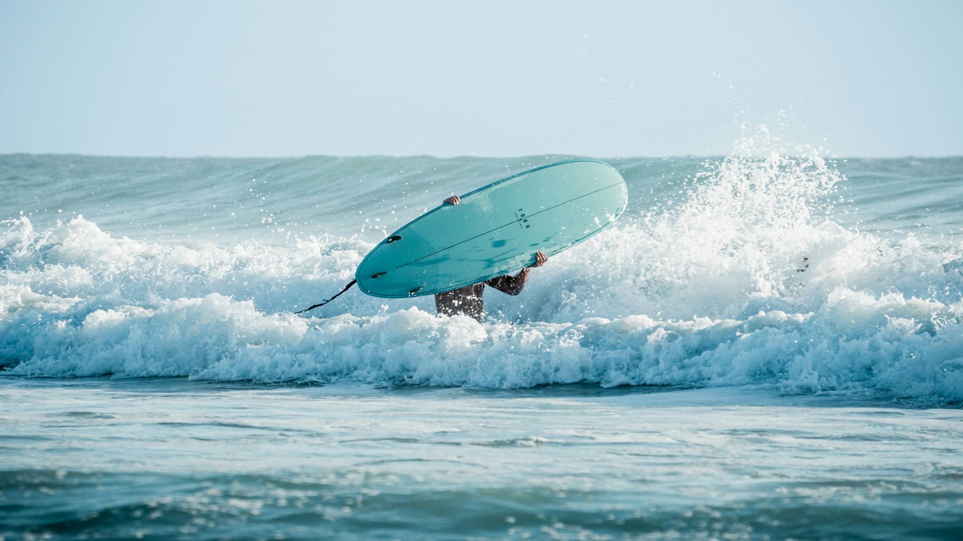 a person jumping in the air with a surfboard