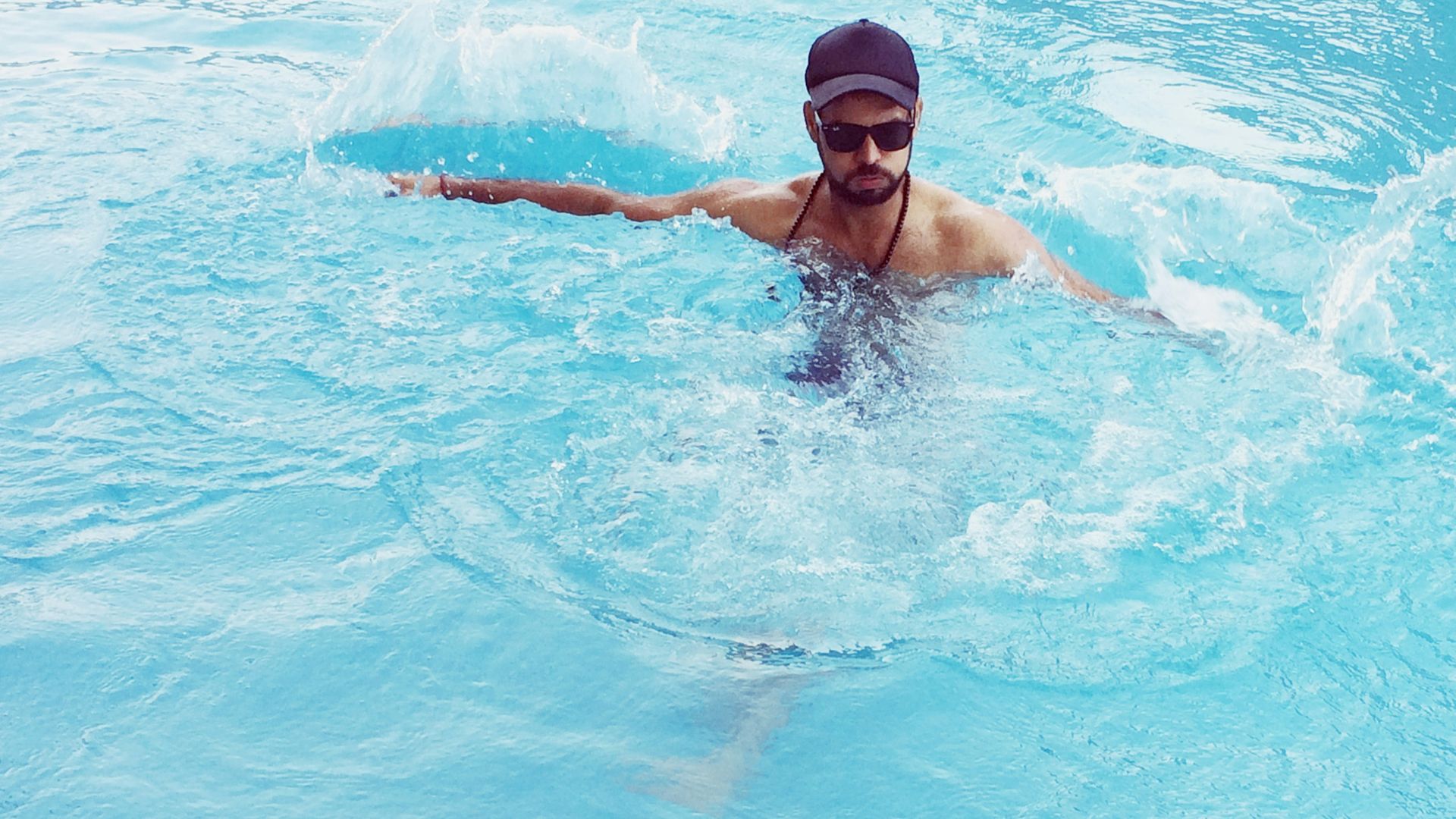 woman in black swimming goggles in water