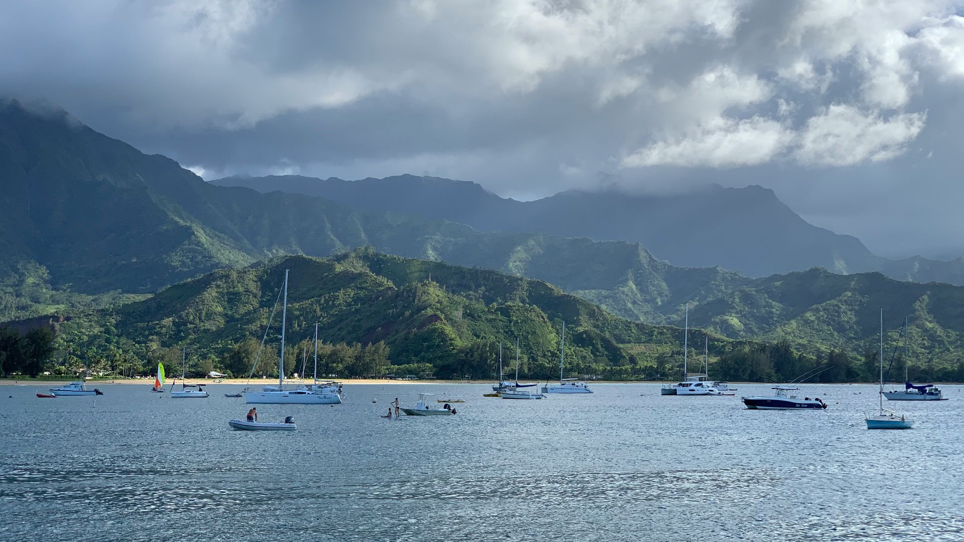 a group of boats floating on top of a body of water