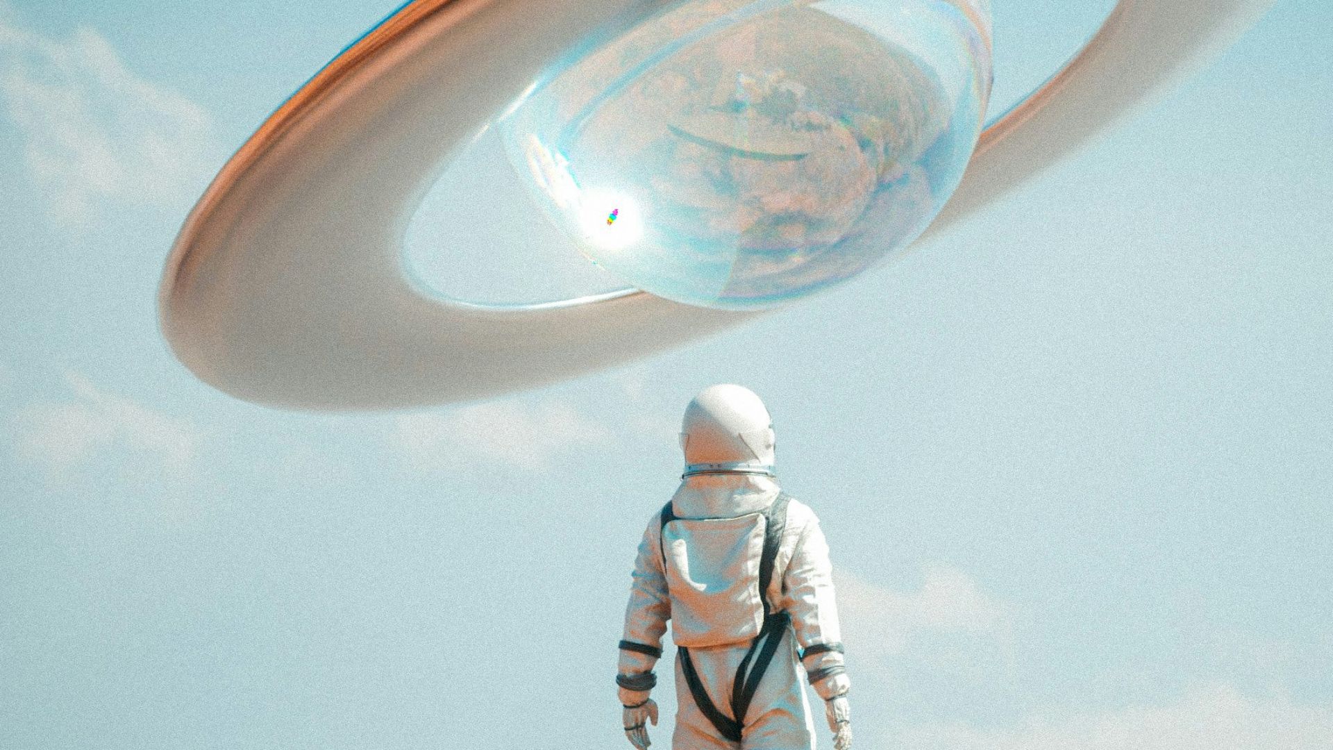 a man in a space suit standing on top of a rock