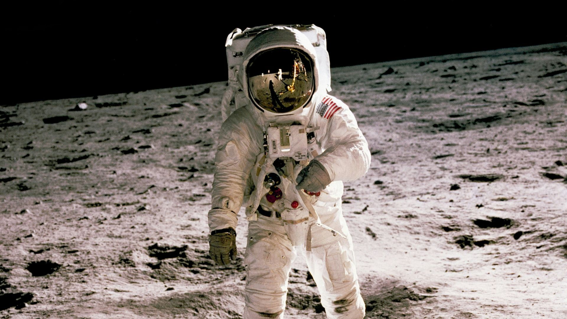 astronaut standing on gray sand