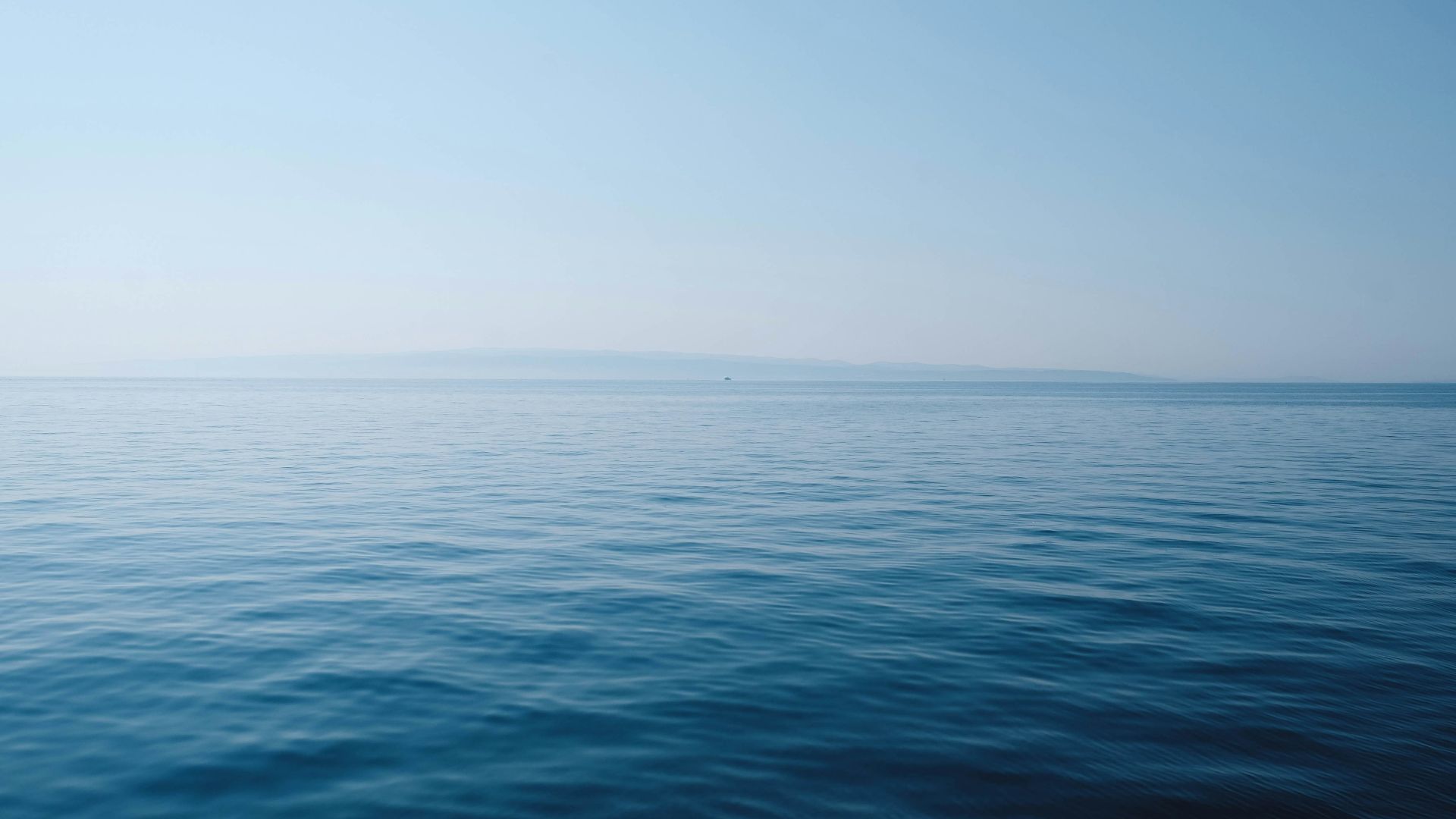 body of water under blue and white sky at daytime