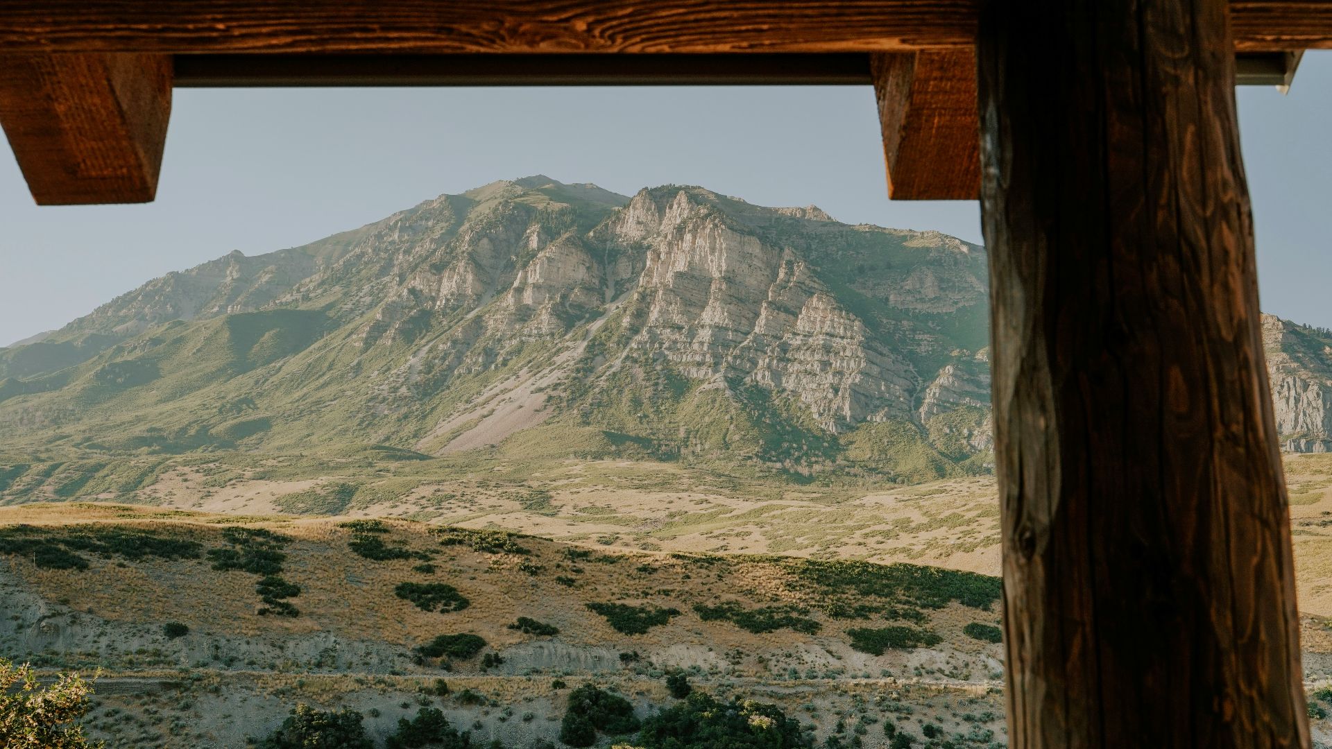 Rocky mountain peak viewed through wooden beams