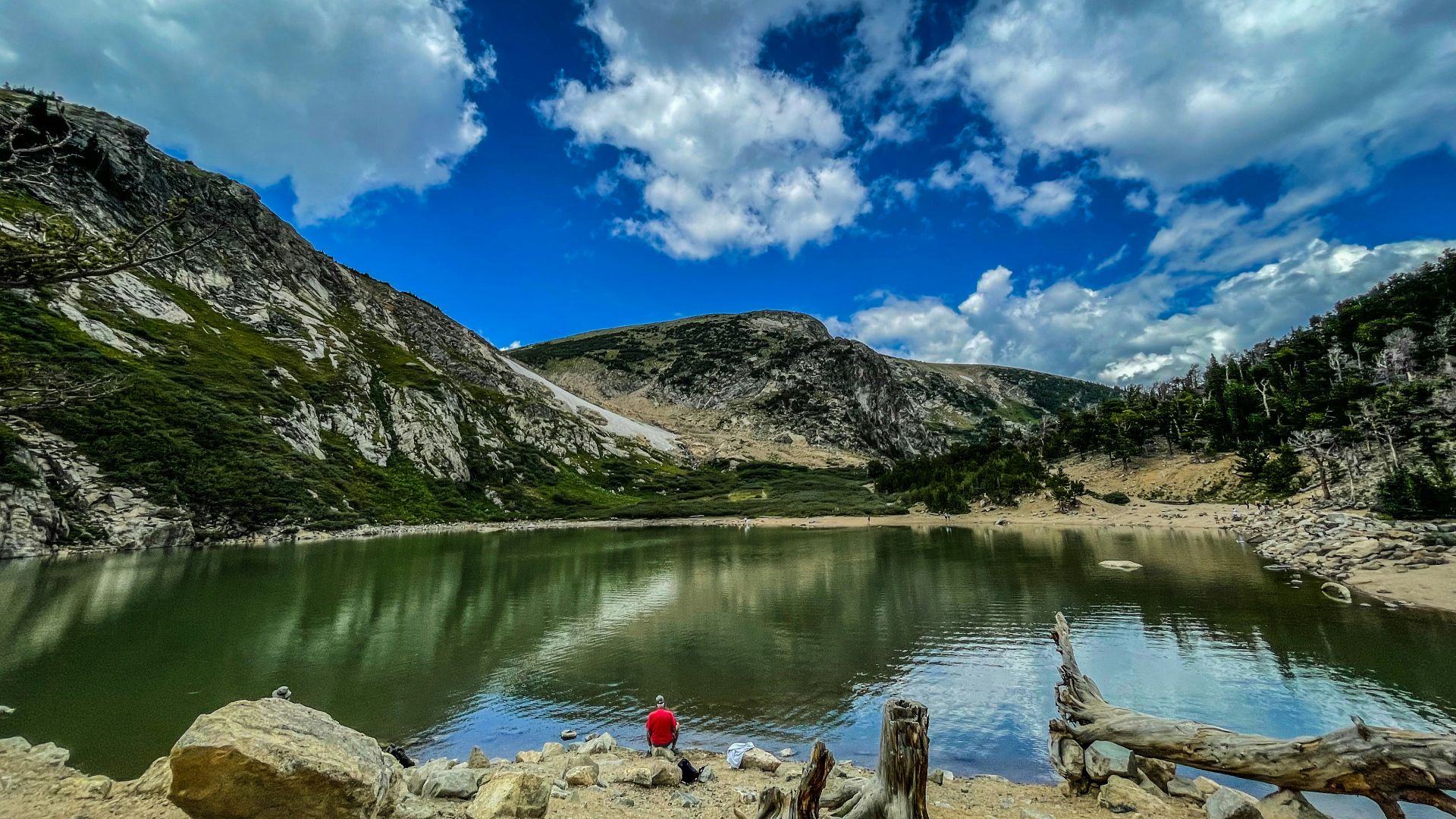 a lake with mountains in the background