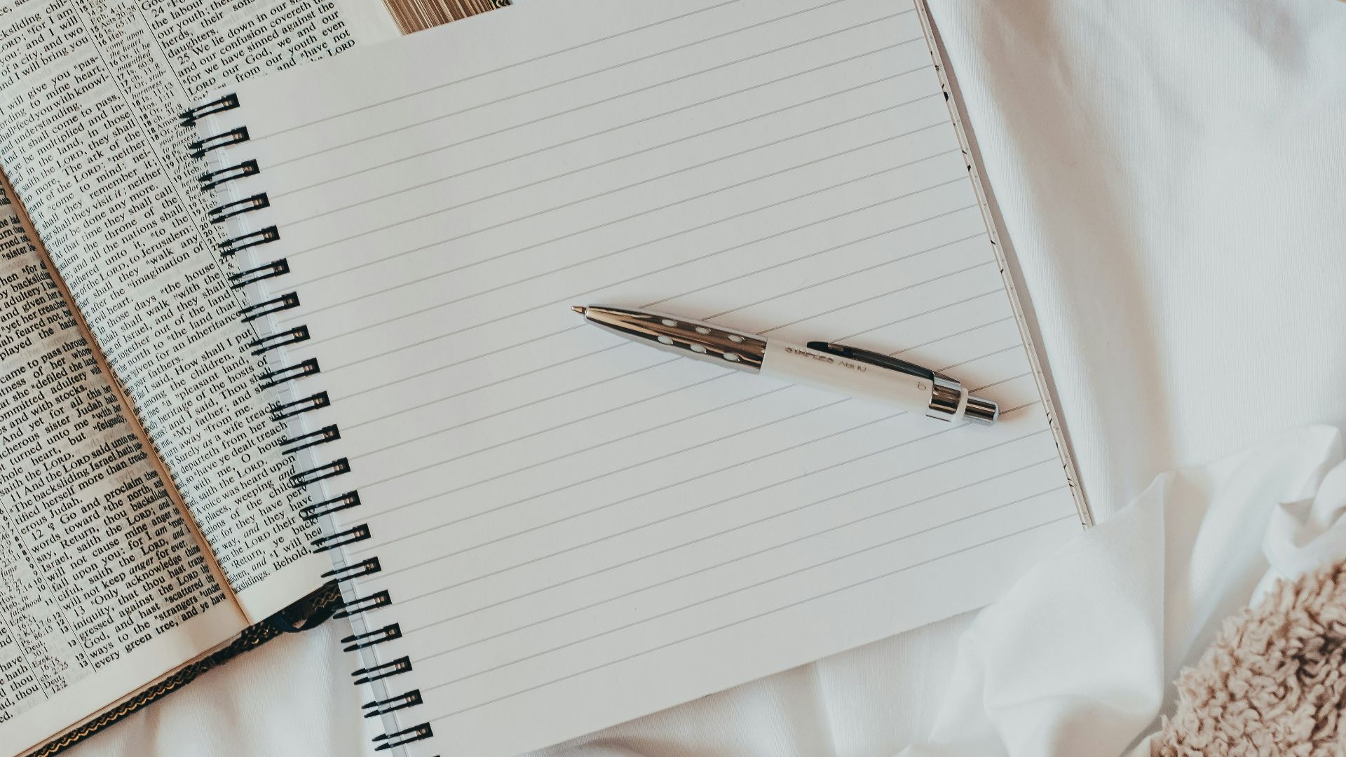 white notebook on white textile