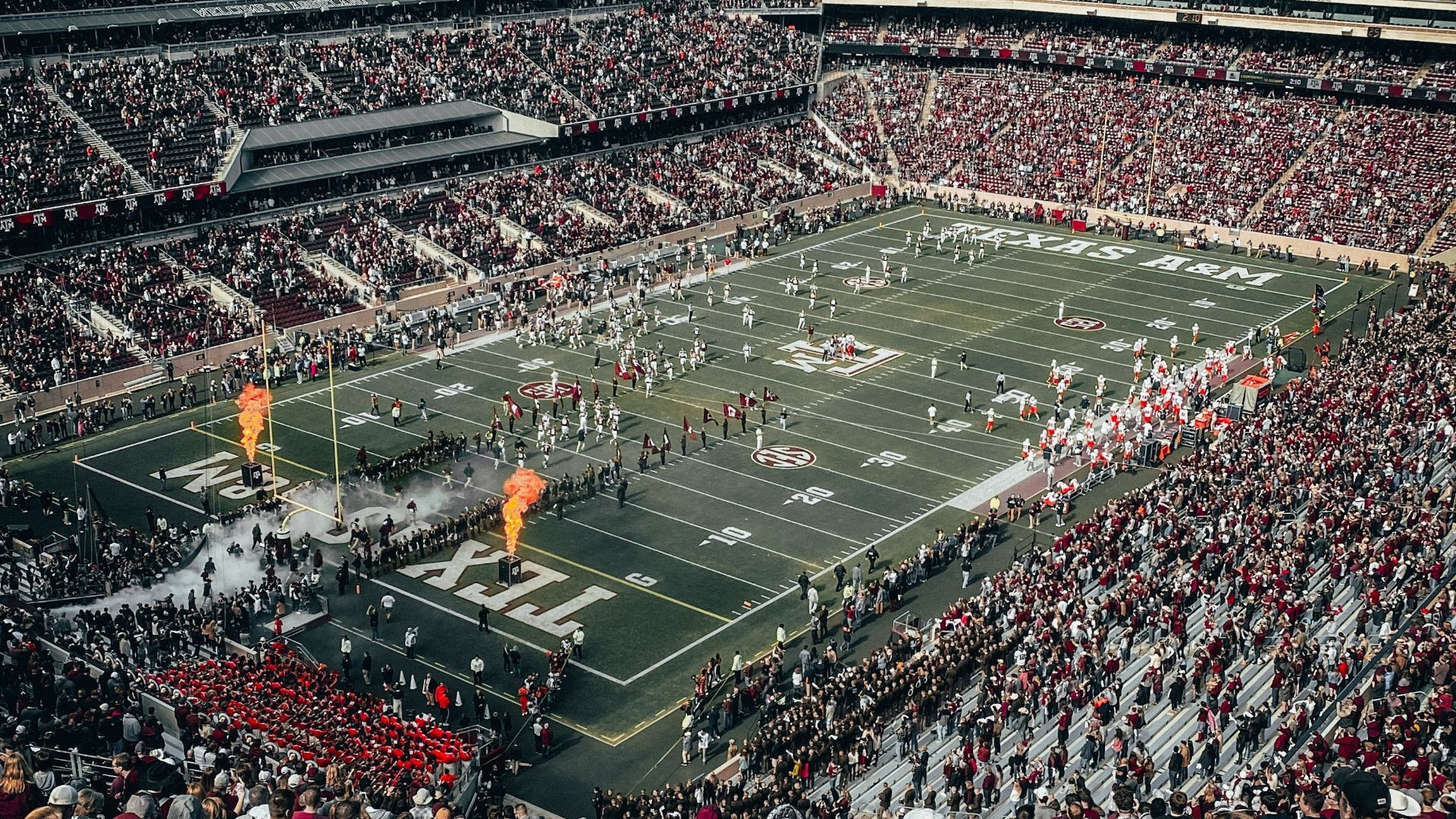 people watching soccer game during daytime